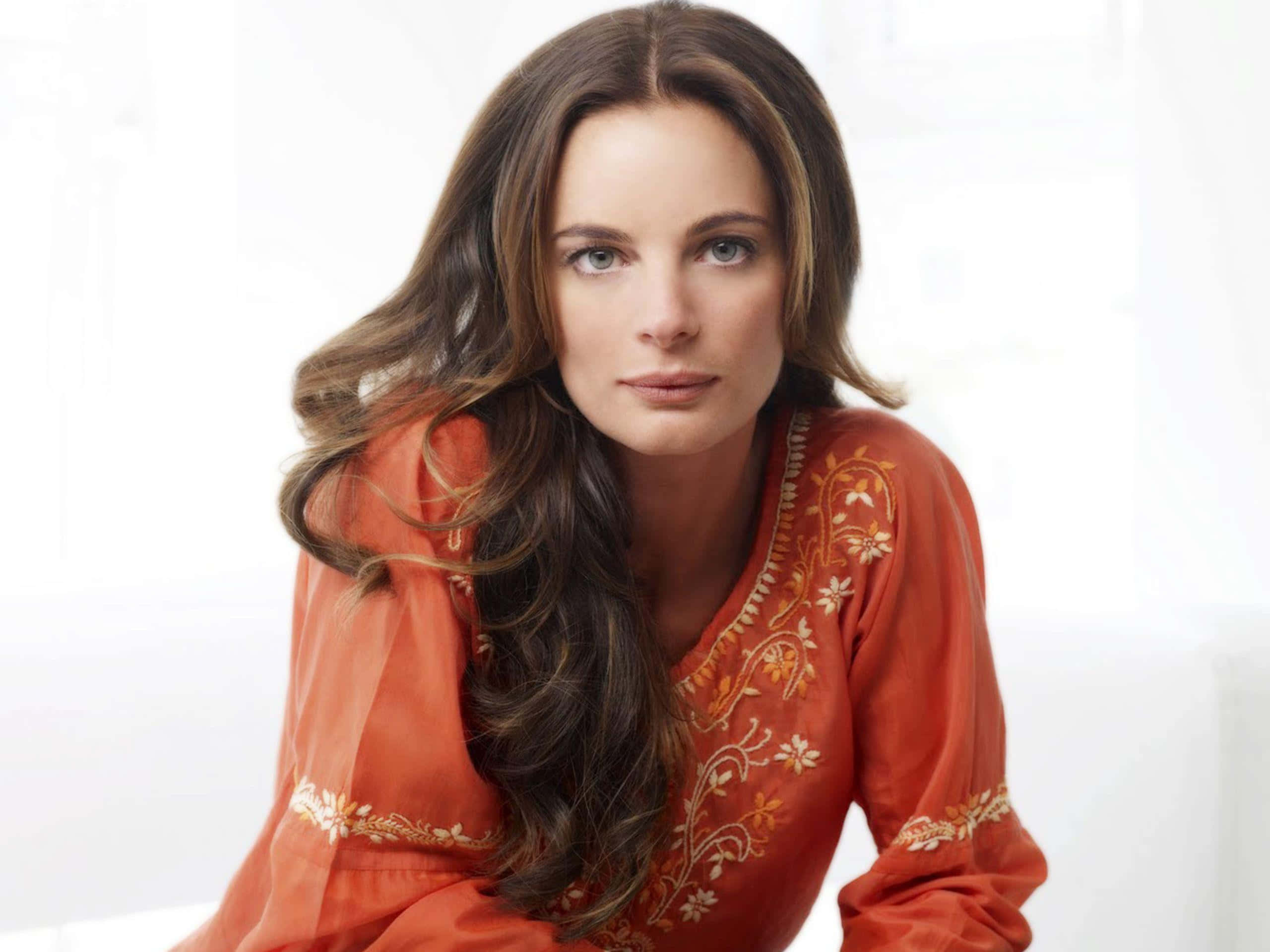 Gabrielle Anwar, orange embroidered top, long brown hair, 2K Desktop Wallpaper