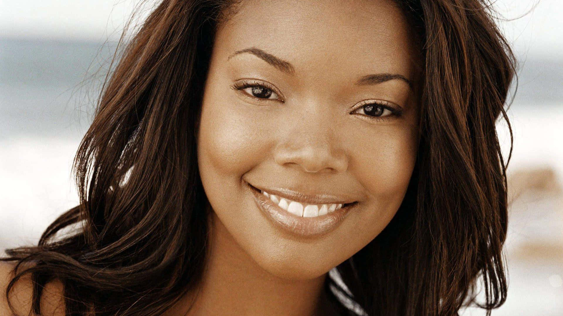 Gabrielle Union, long brown hair, soft blurred beach backdrop, Full HD Desktop Wallpaper