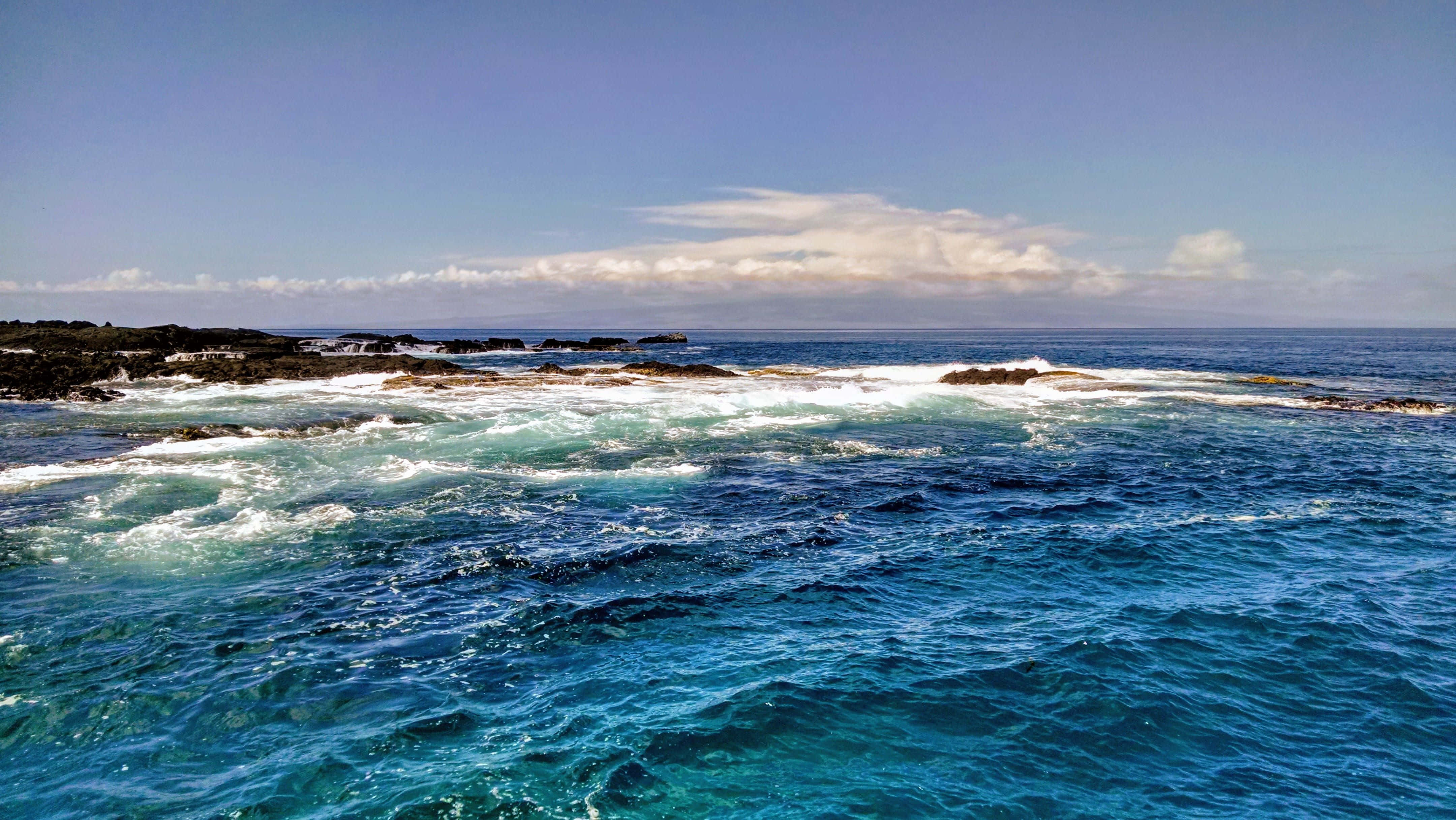Galapagos Islands, turquoise ocean waves, dark volcanic rocks, 4K Desktop Wallpaper