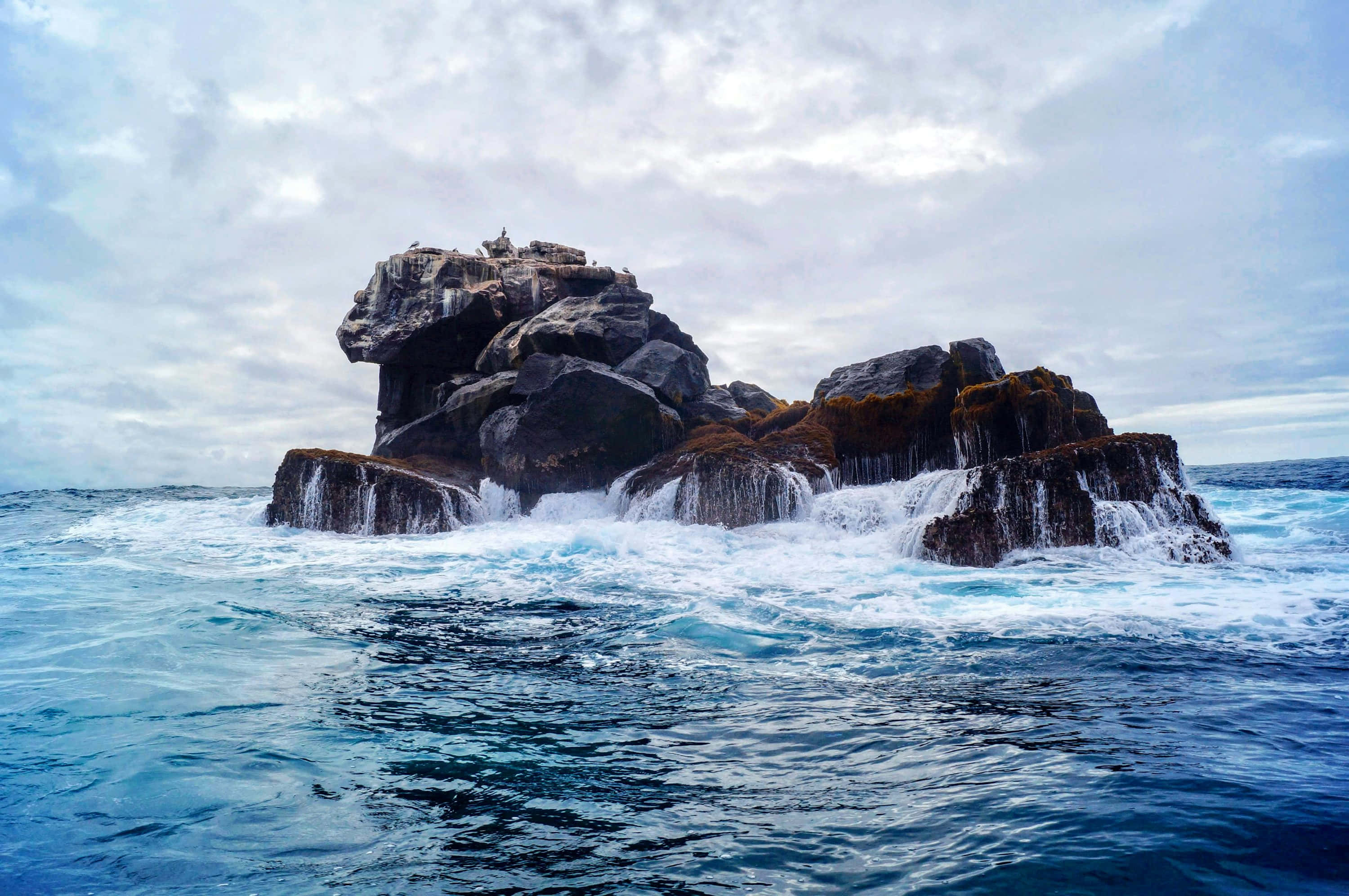 Galapagos, rocky islet, turbulent blue ocean waves, 2K Desktop Wallpaper