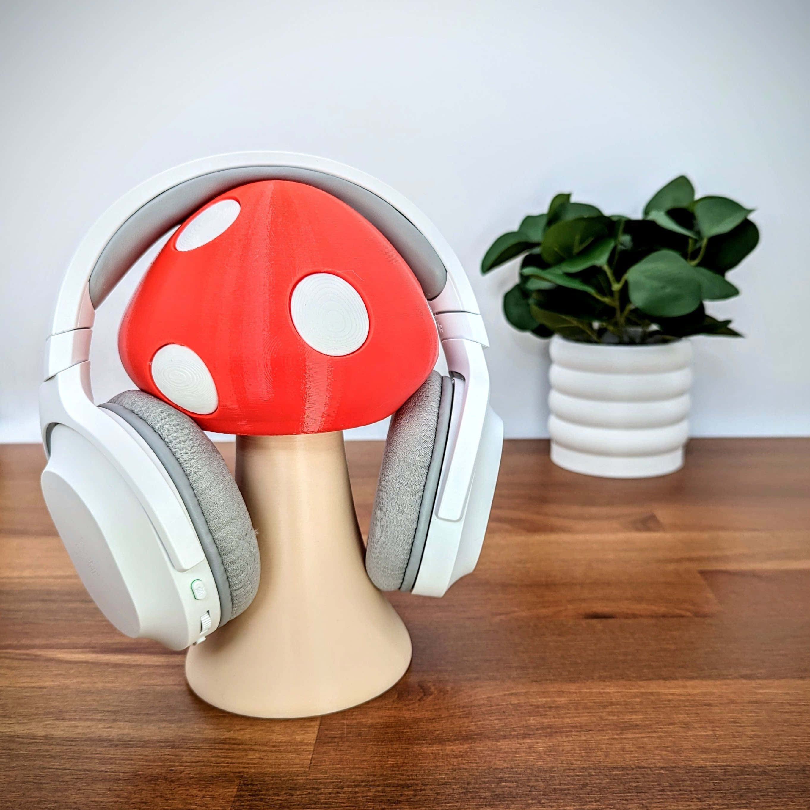 white over-ear headphones, red and white mushroom-shaped stand, potted plant, 2K Desktop Wallpaper