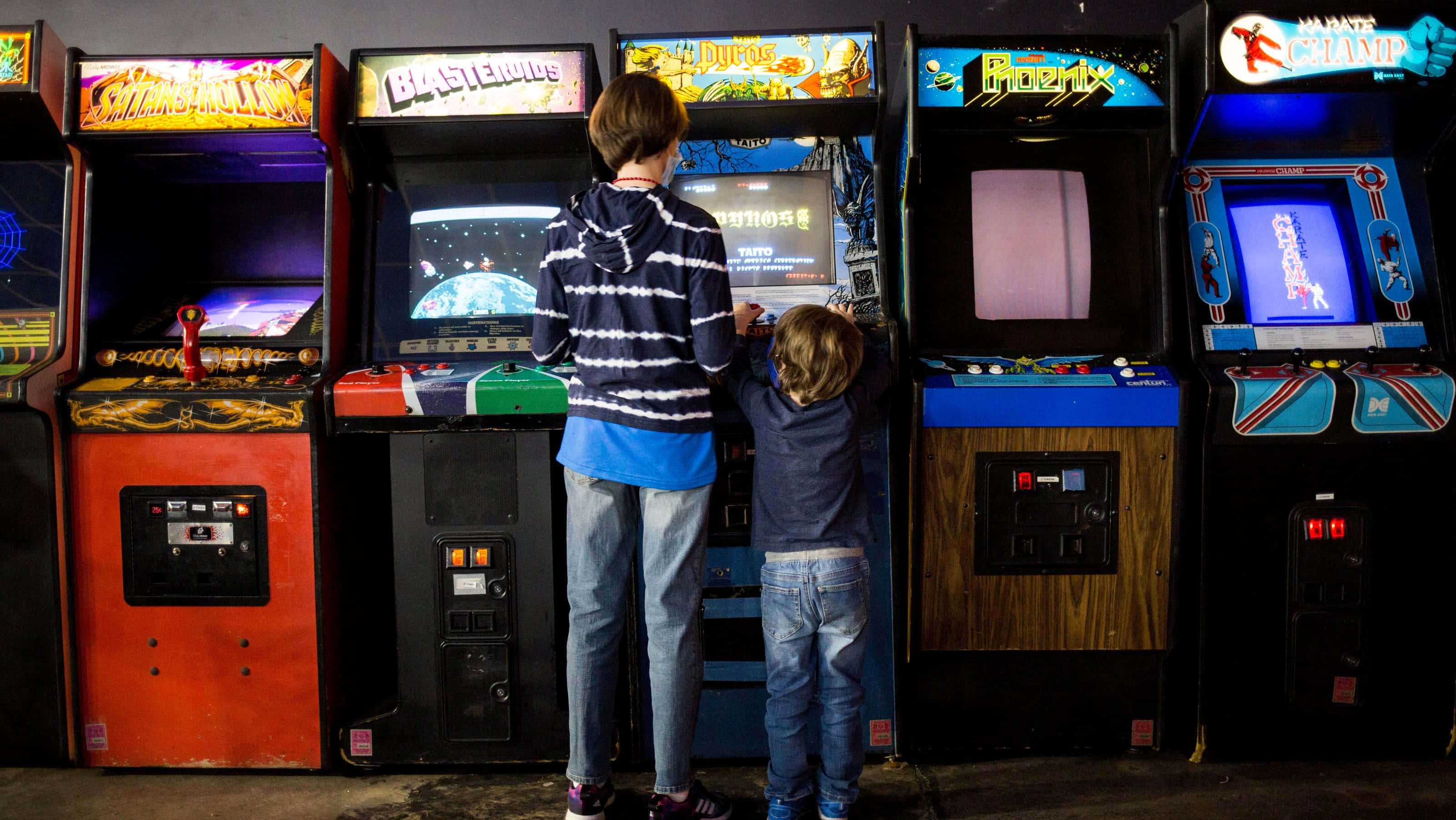 vintage arcade games, retro gaming alley, glowing screens, 2K Desktop Wallpaper