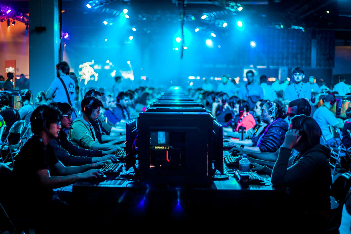 esports tournament, gaming stations, vibrant blue stage lights, HD Desktop Wallpaper