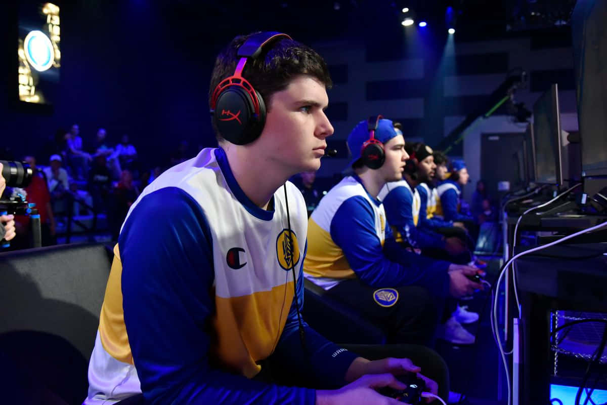 esports players, blue and yellow jerseys, monitors, SD Desktop Wallpaper