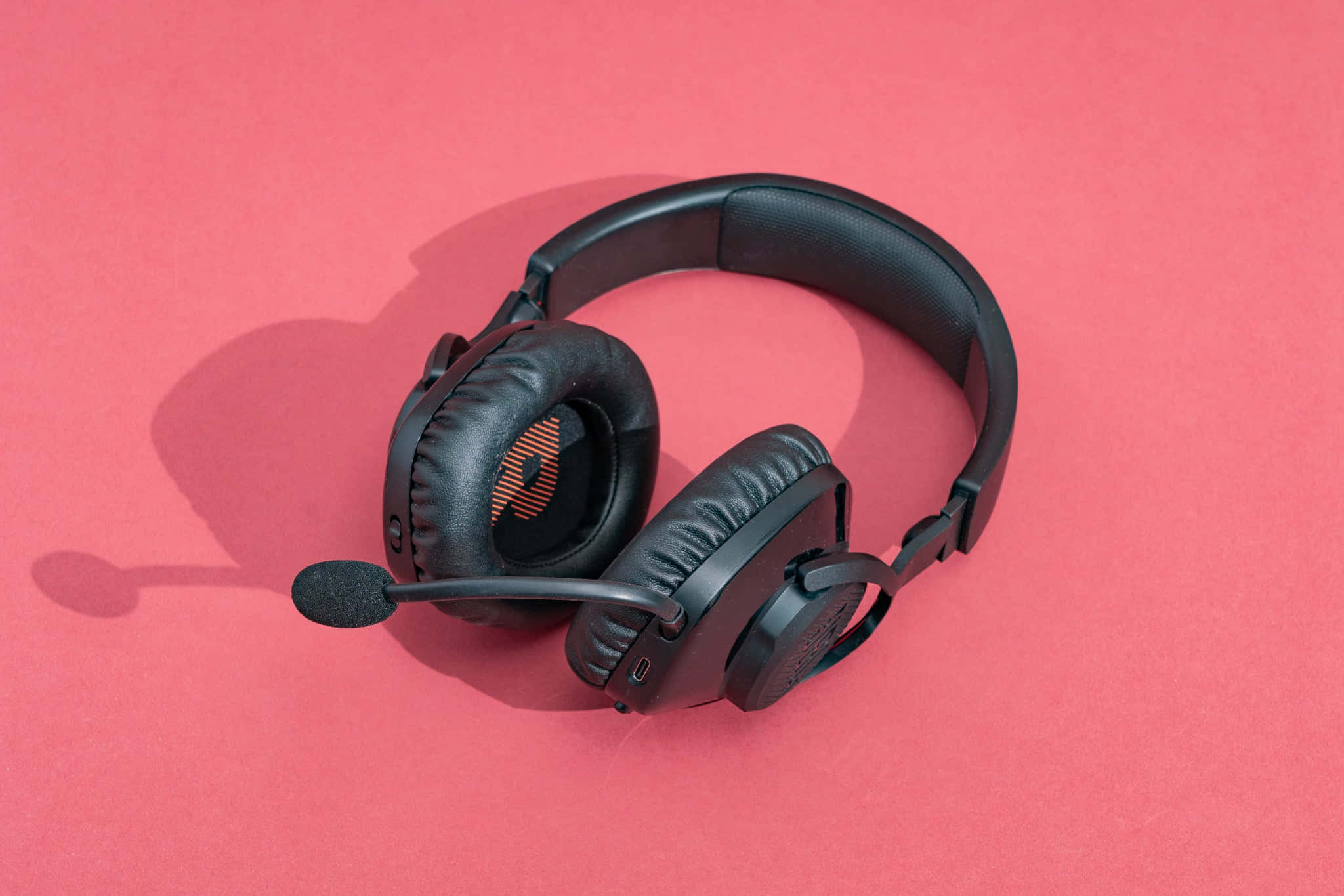 Black gaming headset, microphone, solid coral pink background, Full HD Desktop Wallpaper