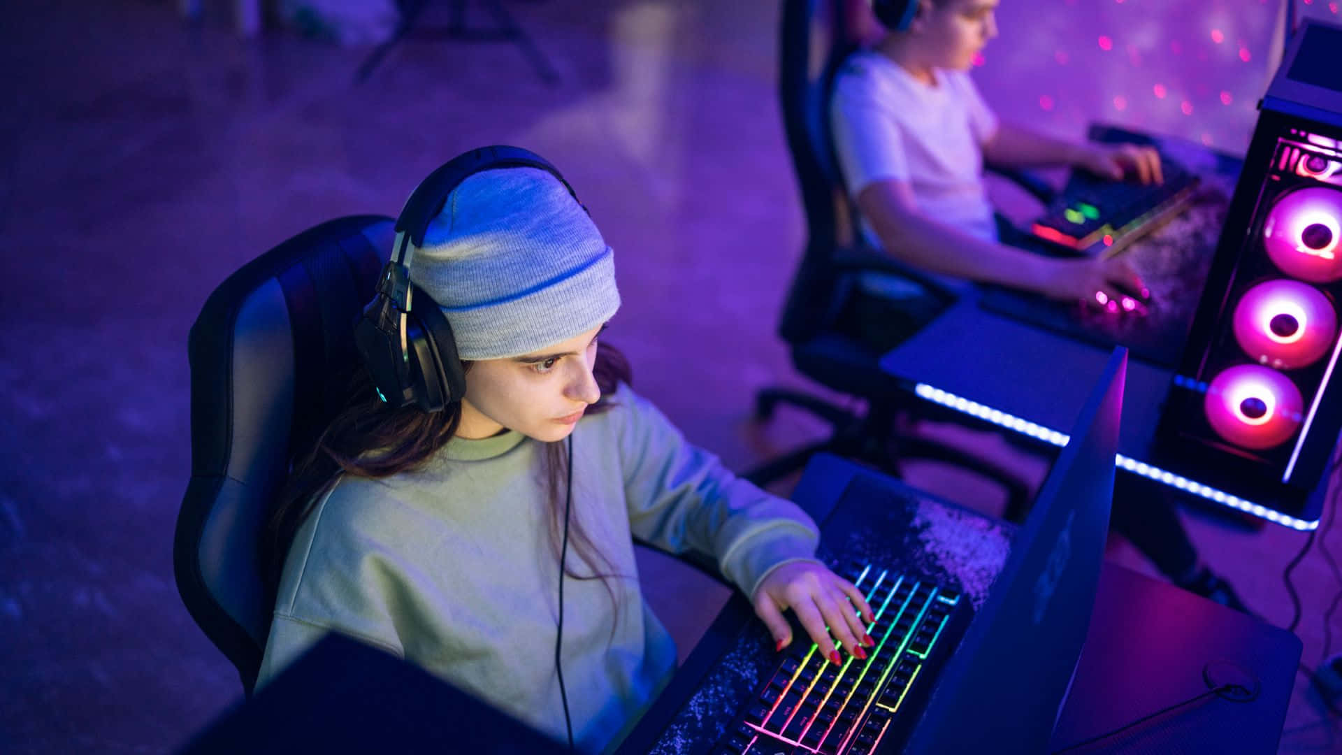gaming tournaments, glowing laptops, dimly lit room, Full HD Desktop Wallpaper