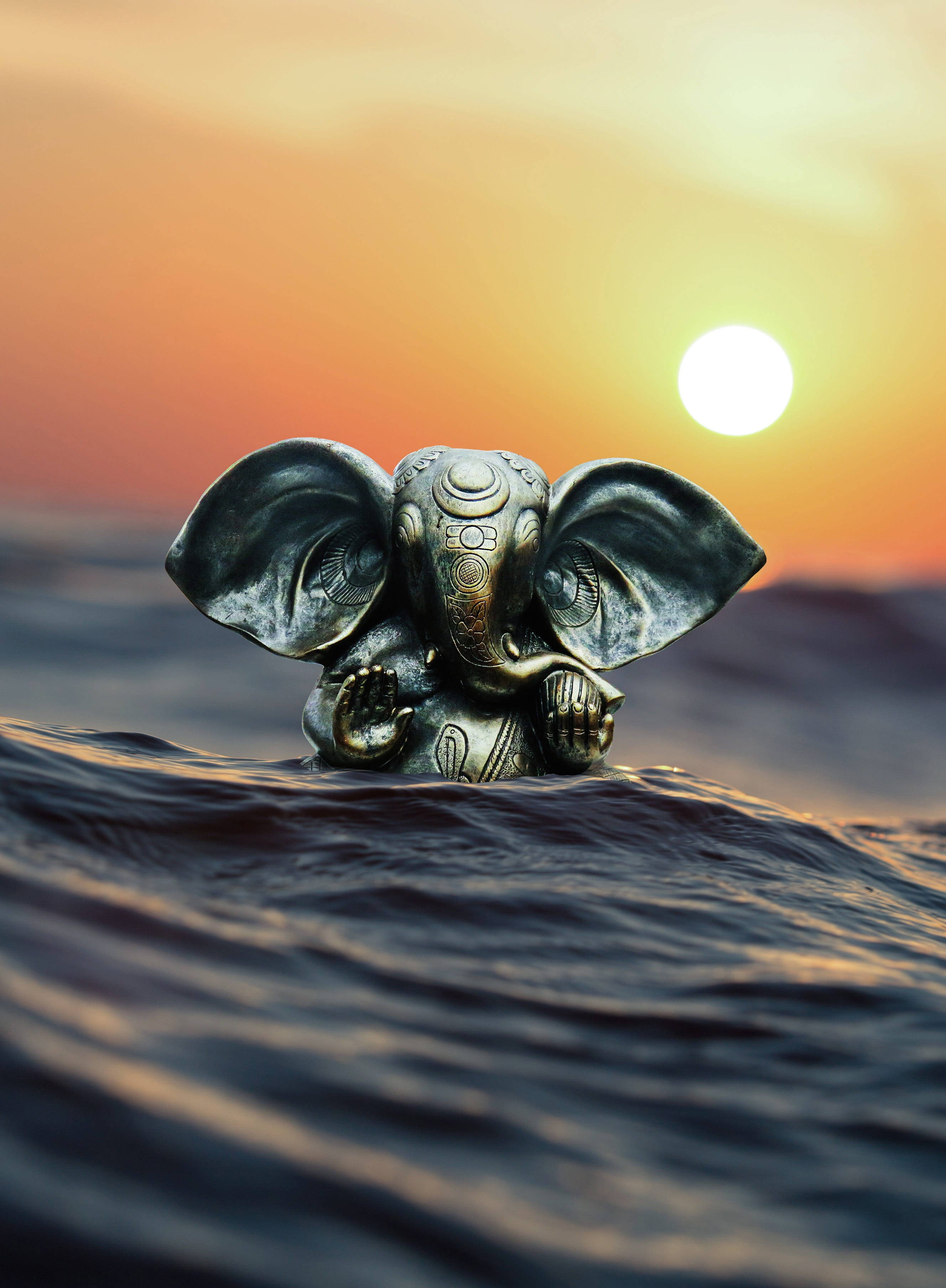 Ganesh Ji HD, bronze Ganesha statue, ocean waves, 2K Phone Wallpaper