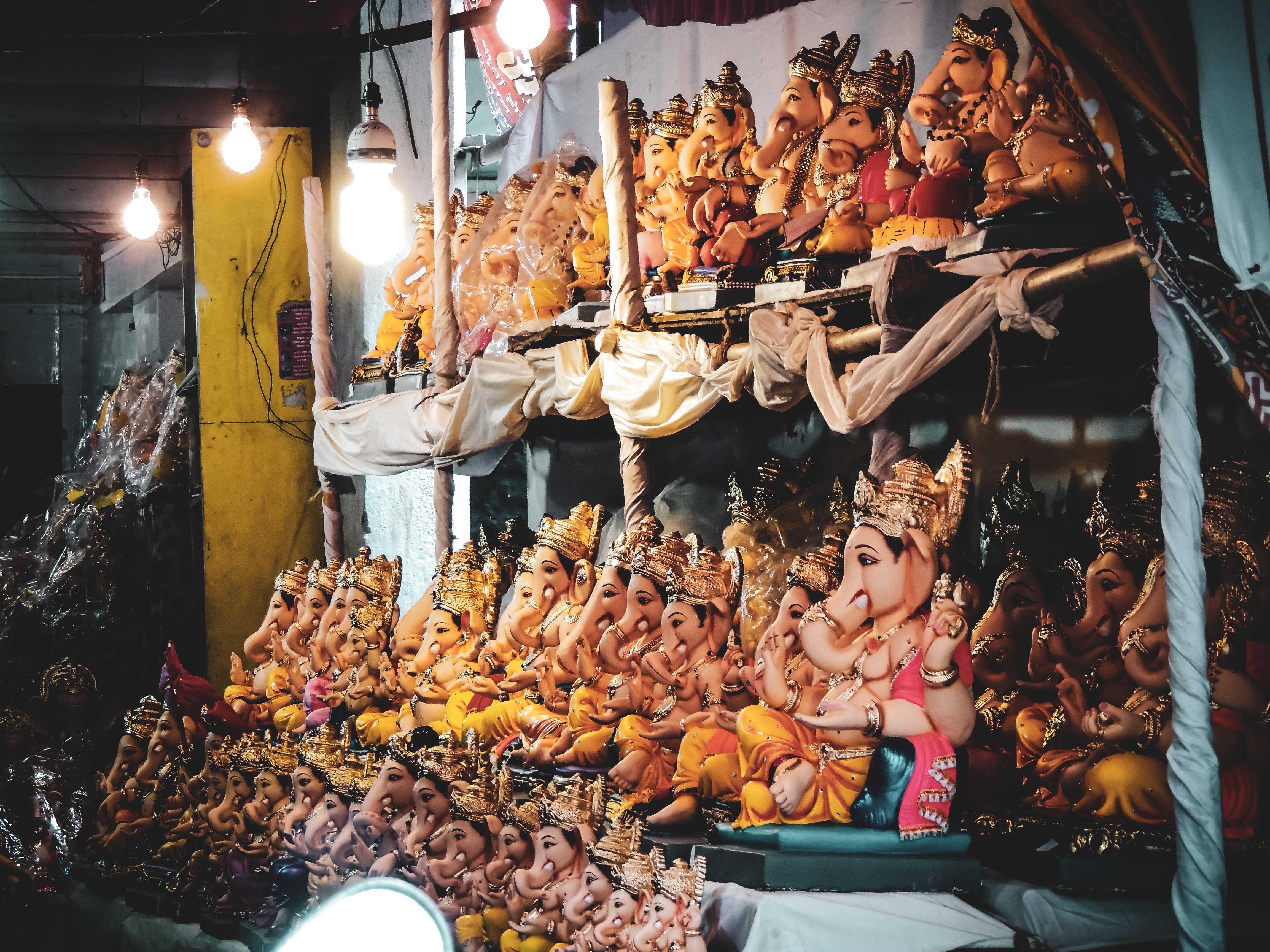 Ganpati Bappa, colorful Ganesha statues, bustling temple market stall, 4K Desktop Wallpaper