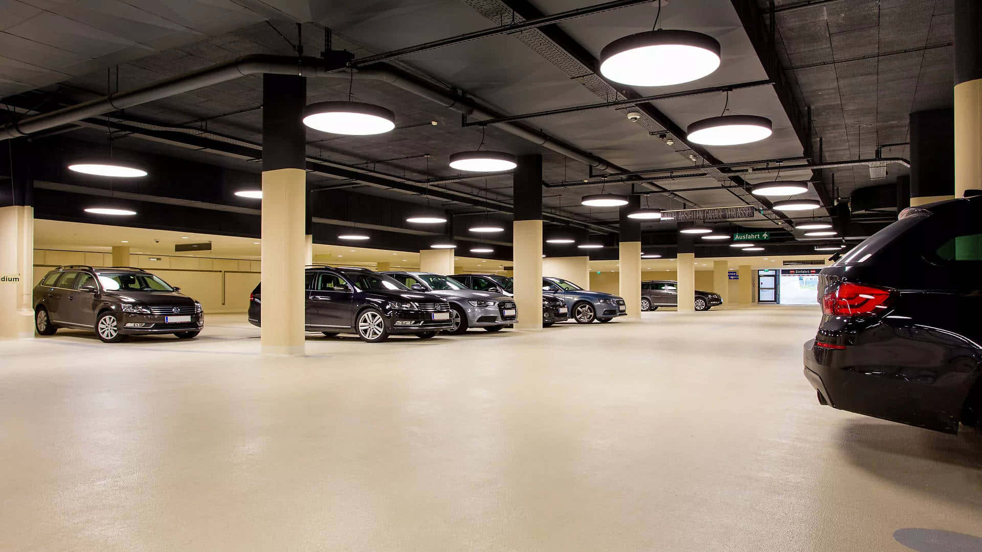 modern underground parking garage, sleek cars, bright circular lights, Full HD Desktop Wallpaper