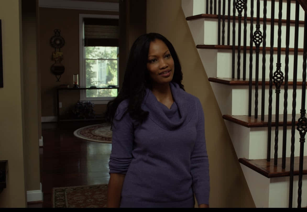 Garcelle Beauvais, purple cowl-neck sweater, wooden staircase, SD Desktop Wallpaper