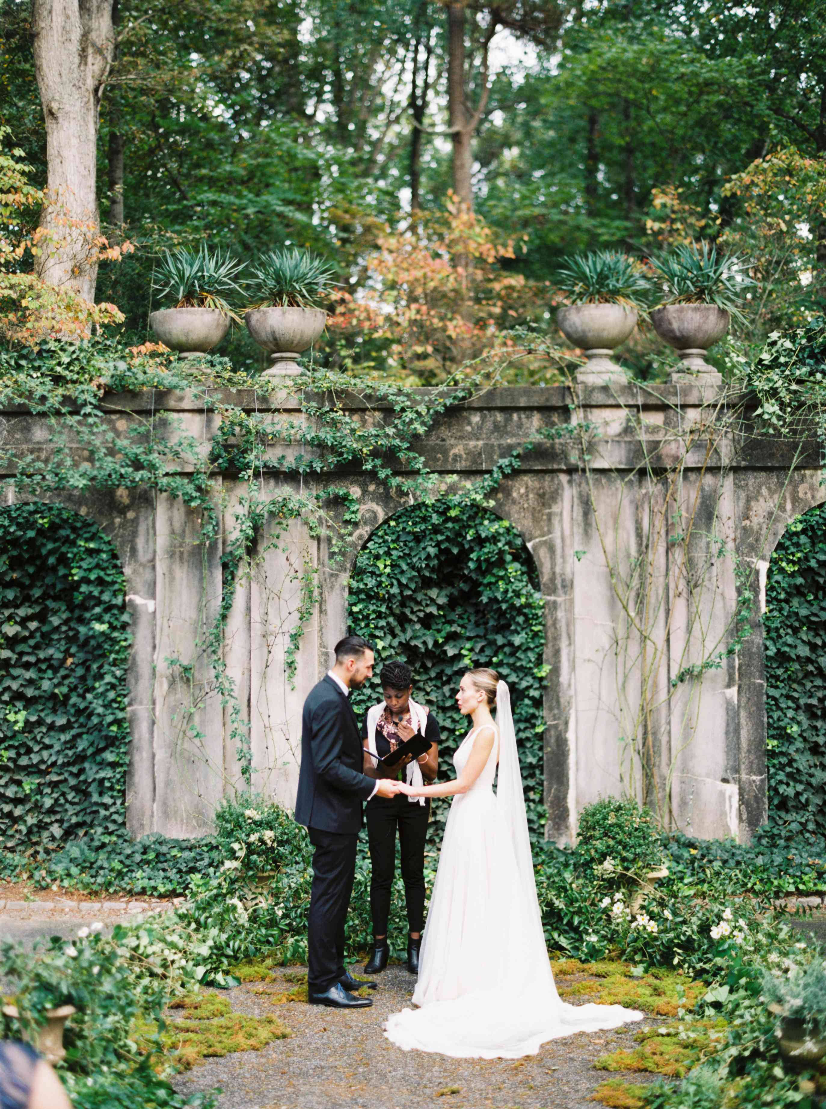 mossy stone archway, lush green garden, bride, 2K Phone Wallpaper