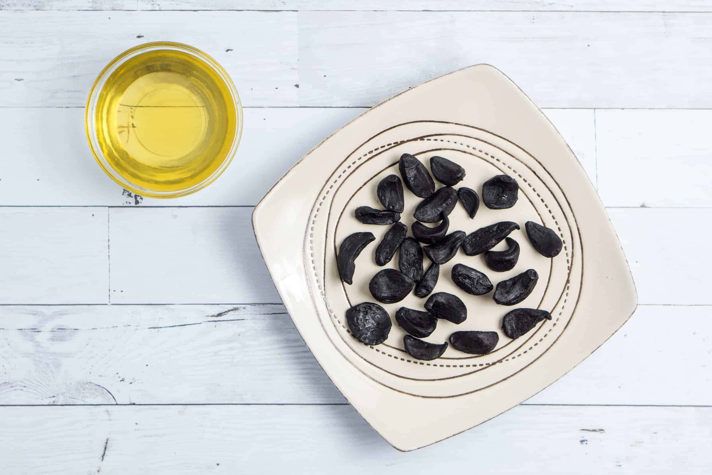 black garlic, beige plate, golden oil, Full HD Desktop Wallpaper