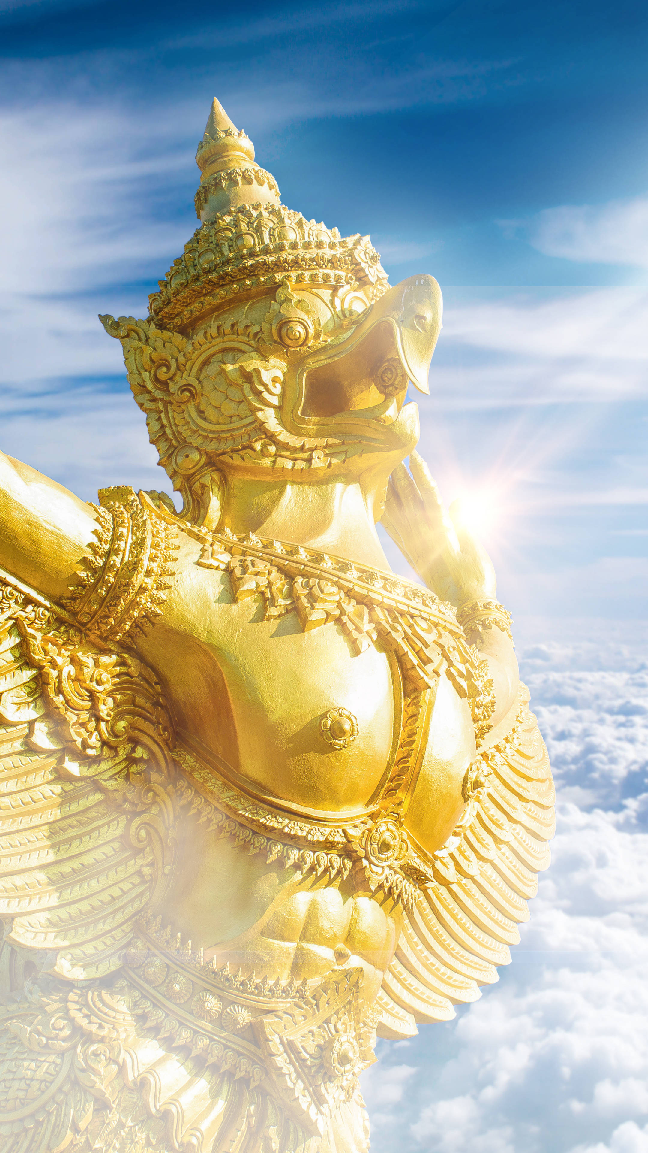 Golden Garuda, soars above clouds, sun rays bursting from behind its head, 4K Phone Wallpaper