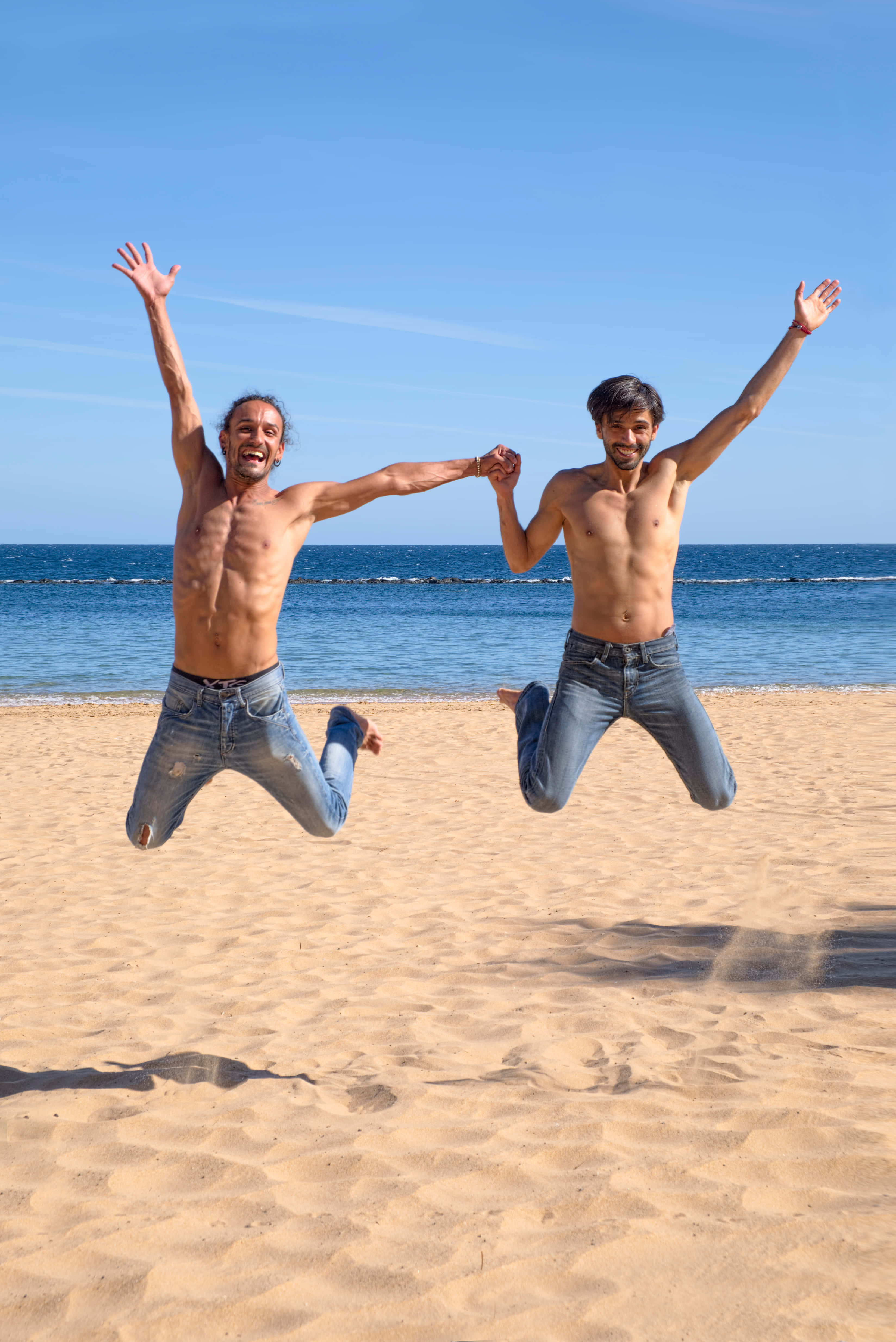 shirtless men, sunlit sandy beach, turquoise ocean, 4K Phone Wallpaper