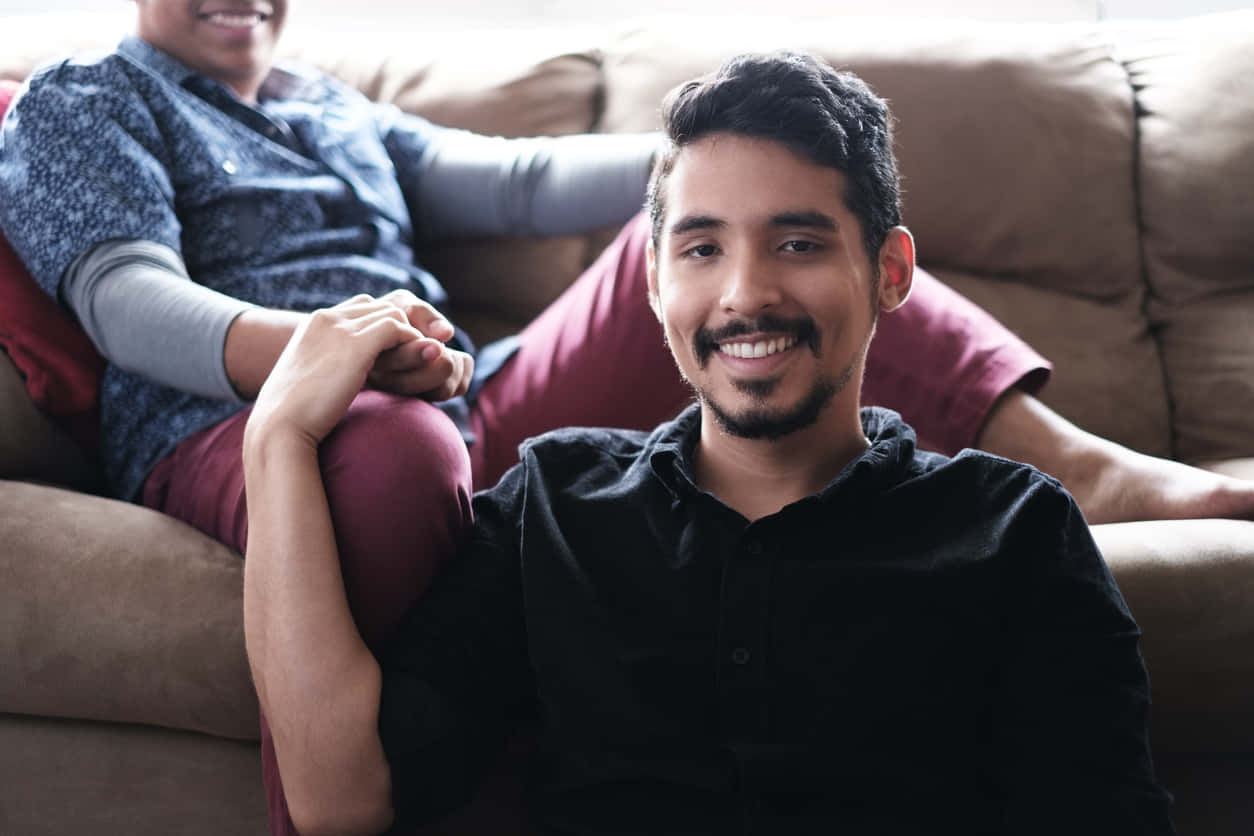 Gay Latino, brown couch, black shirt, SD Desktop Wallpaper