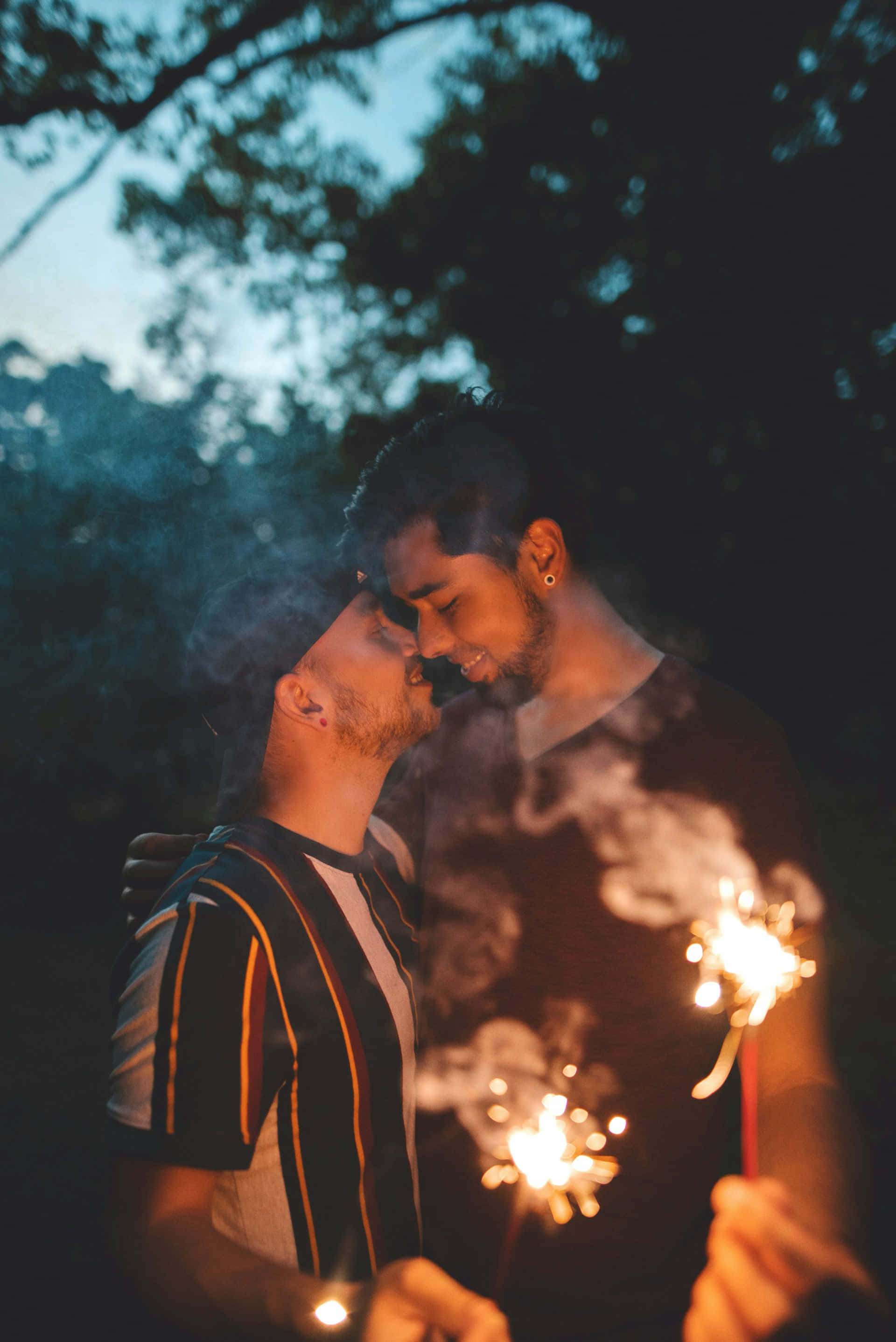 sparklers, twilight trees, warm light, 2K Phone Wallpaper