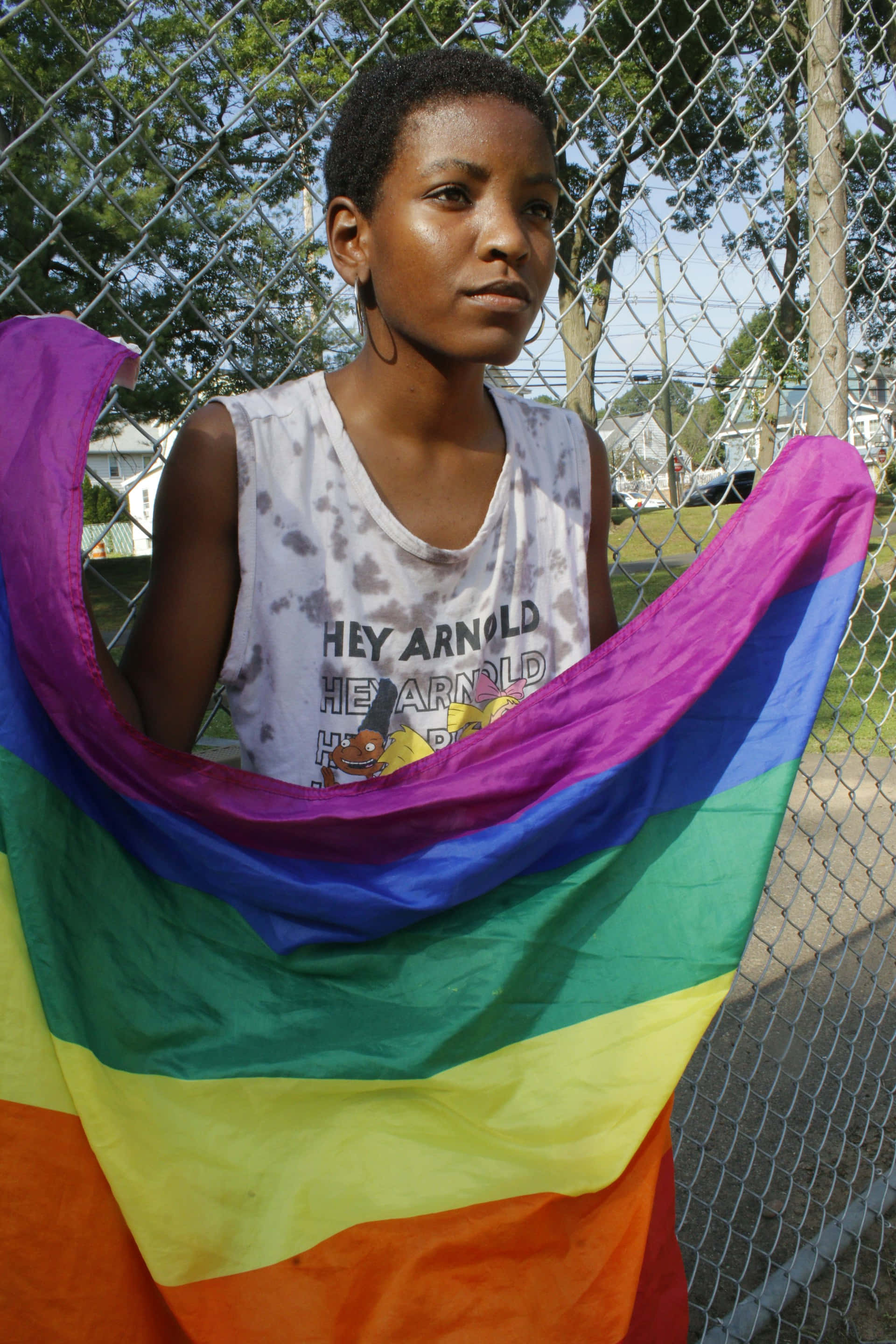 rainbow flag, chain-link fence, short dark hair, 2K Phone Wallpaper