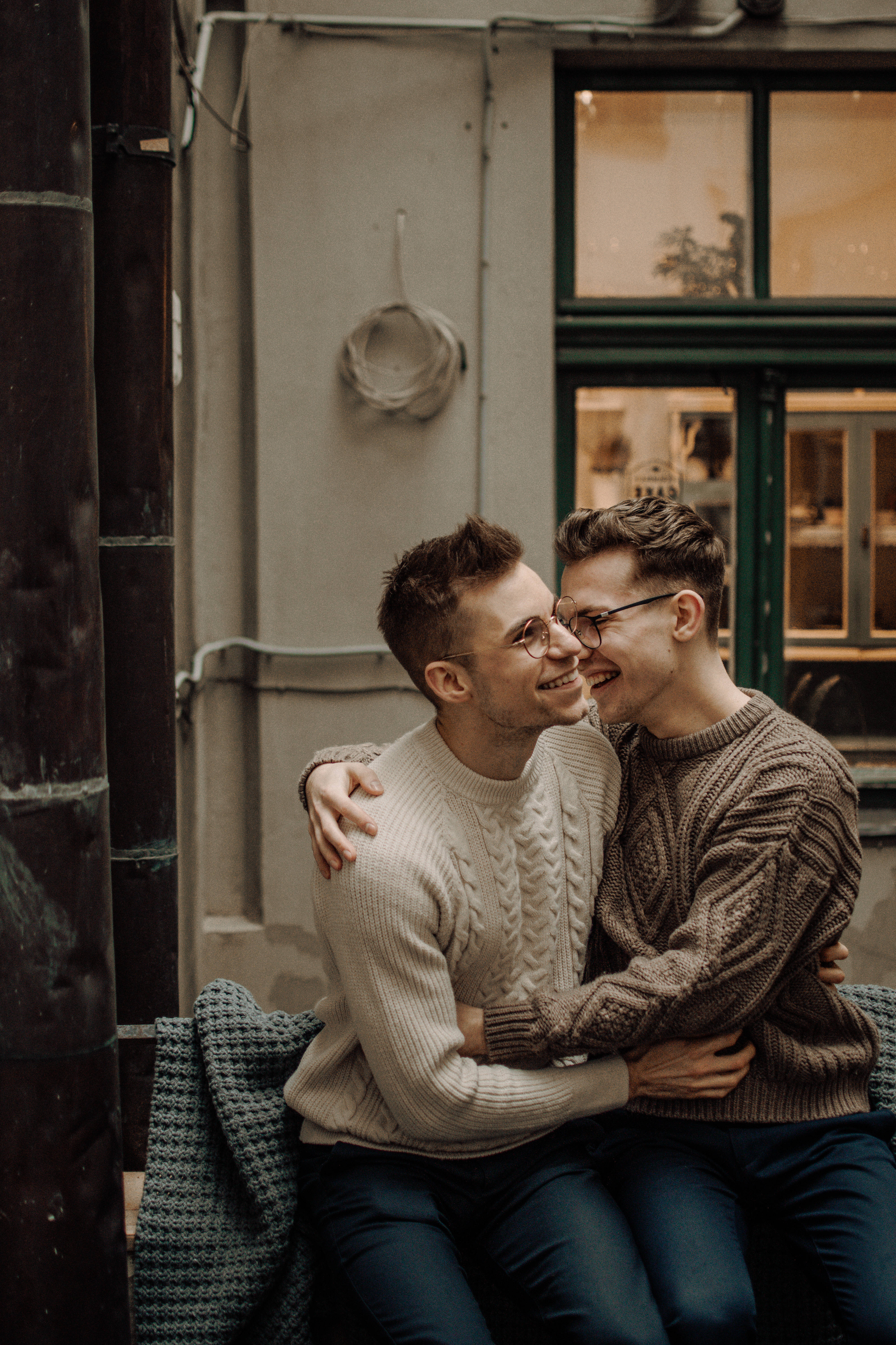 boys couple cuddling, knit sweaters, cozy urban bench, 5K Phone Wallpaper