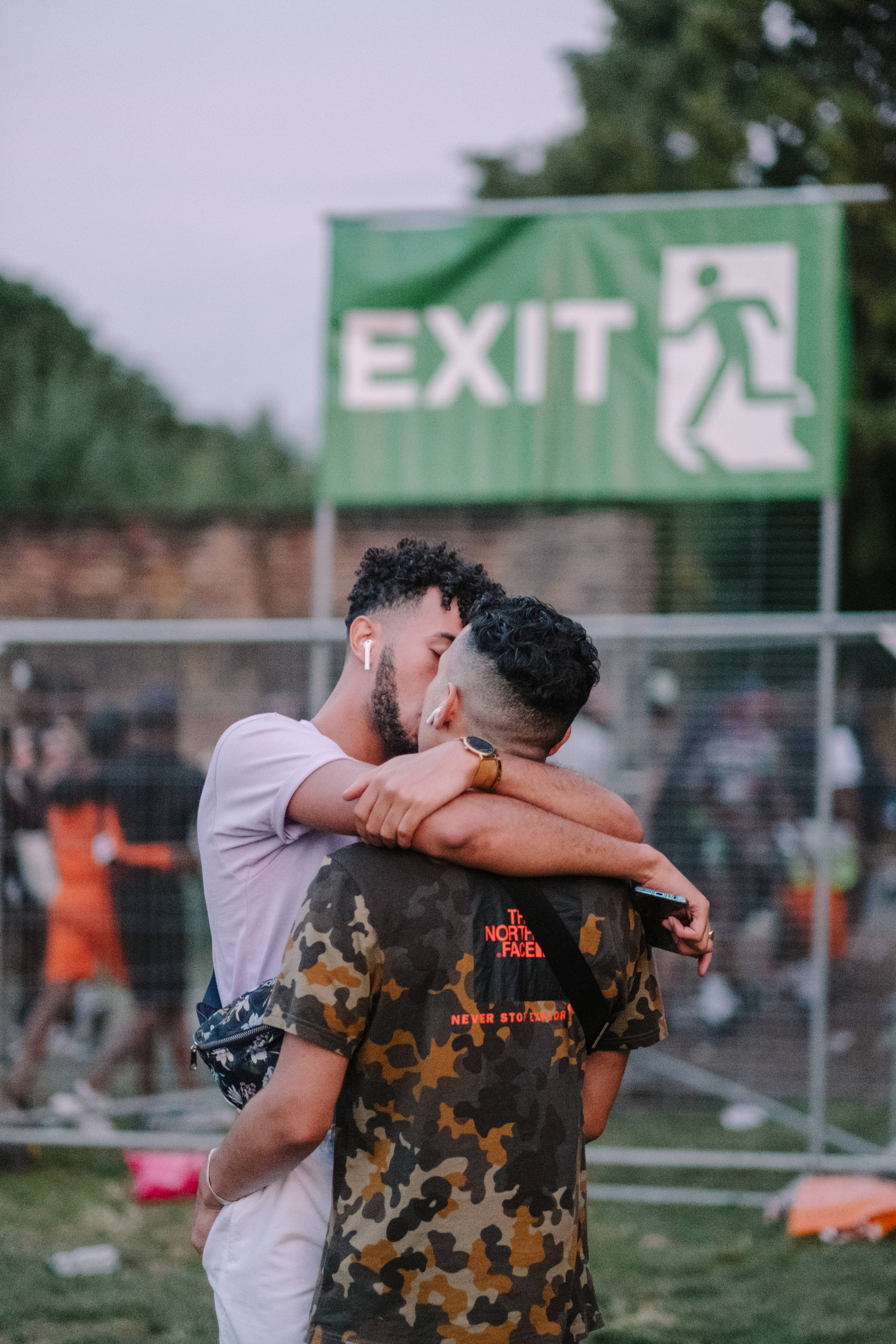 green exit sign, outdoor event, gay couple, 5K Phone Wallpaper