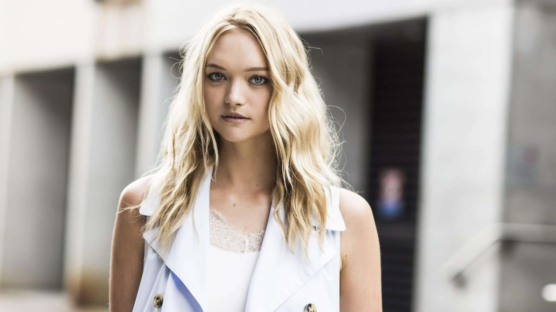 Gemma Ward, white sleeveless vest, blurred urban building backdrop, Full HD Desktop Wallpaper