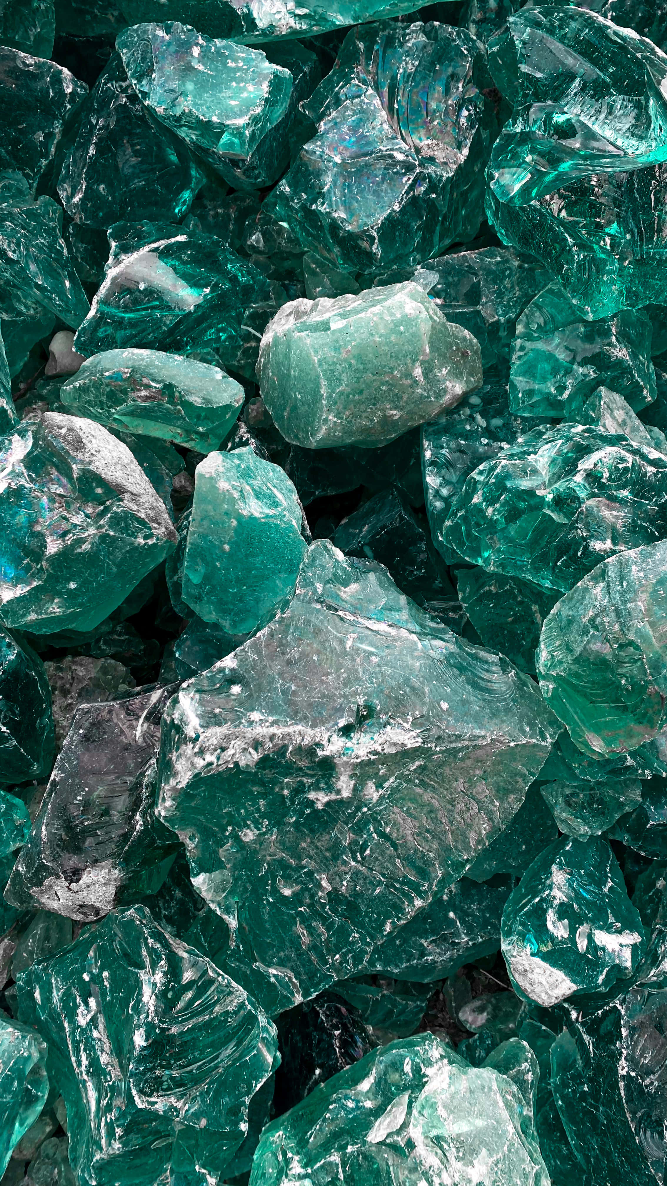 rough emerald green gemstones, jagged edges, translucent facets, 4K Phone Wallpaper