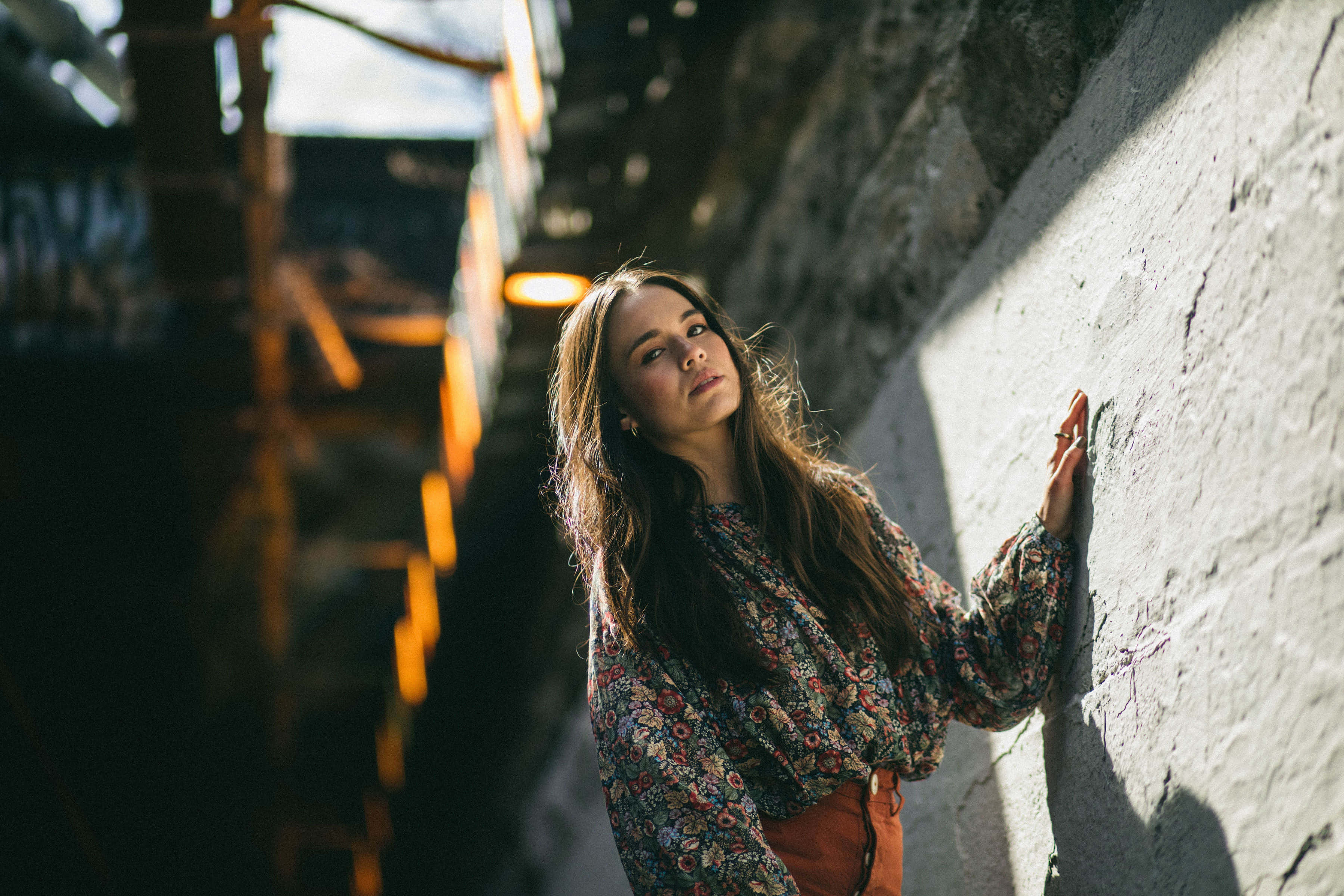Genevieve Kang, floral blouse, sunlit stone wall, 2K Desktop Wallpaper