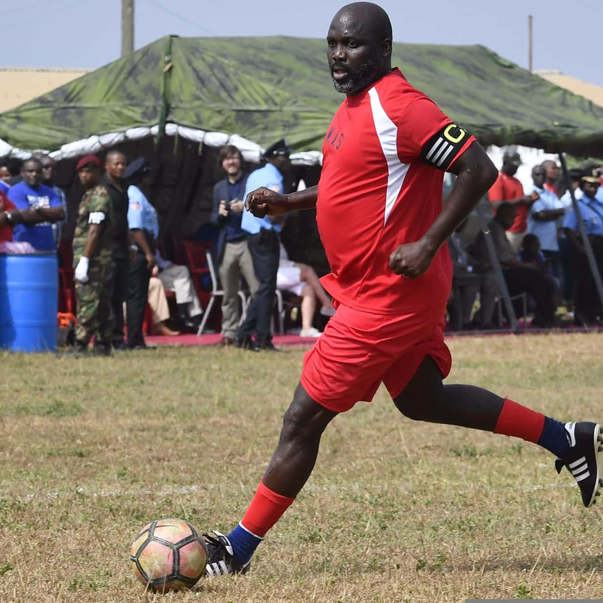 George Weah, red soccer gear, dry grass, SD Desktop Wallpaper