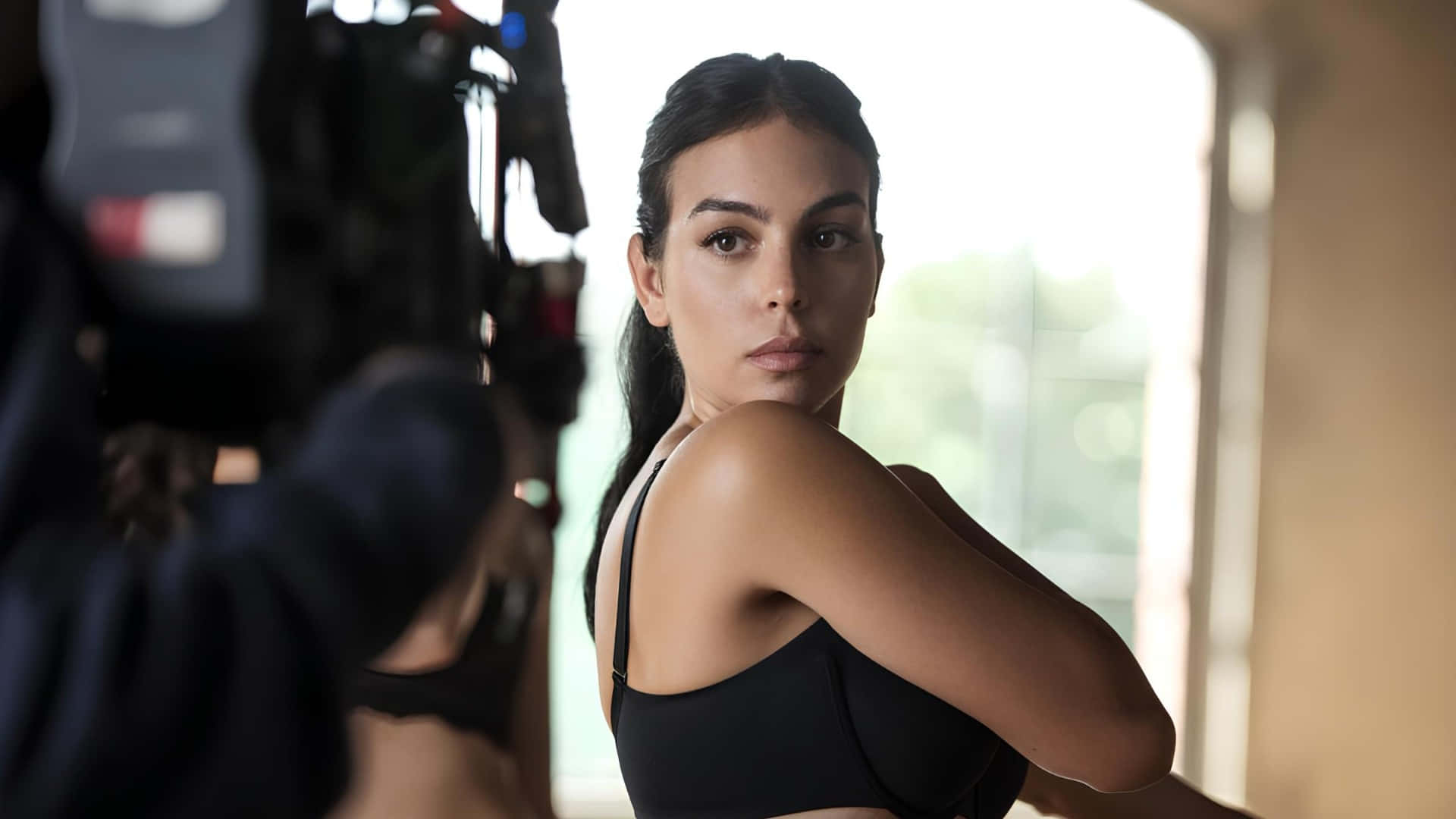 Georgina Rodríguez, black sports bra, softly lit studio, Full HD Desktop Wallpaper