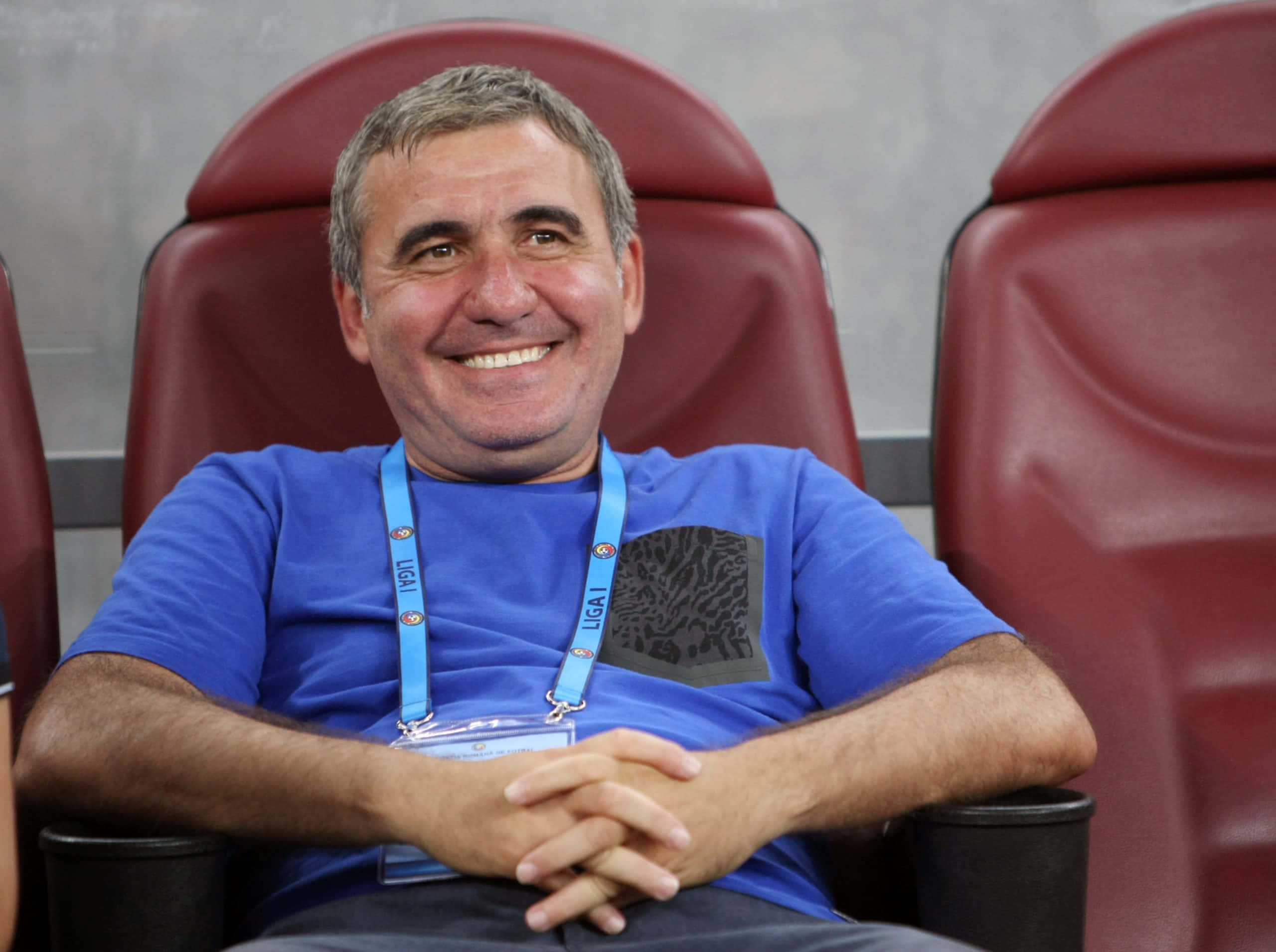 Gheorghe Hagi, blue shirt, red stadium chair, 2K Desktop Wallpaper