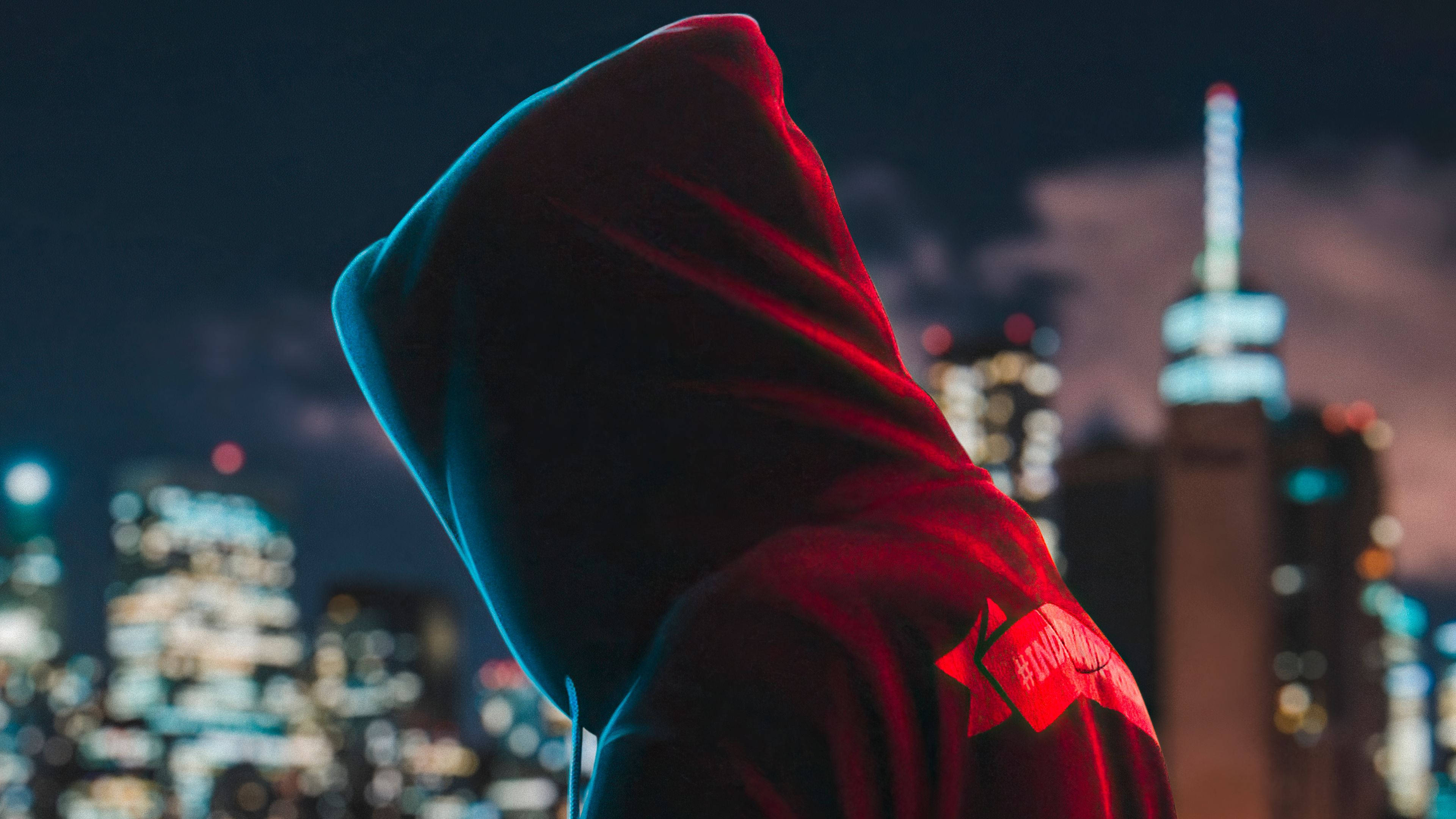 red and blue hoodie, neon-lit city skyline, night, 4K Desktop Wallpaper