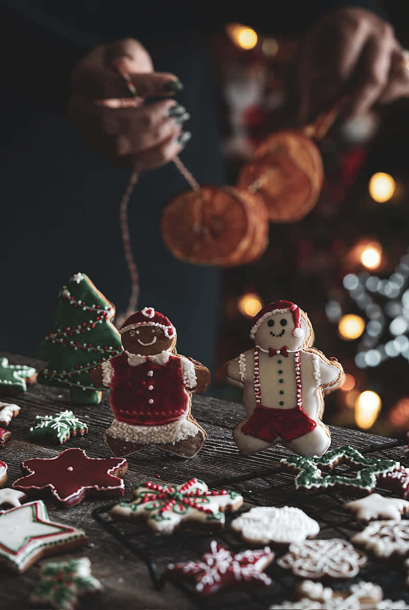 Gingerbread men, red green and white icing, dark wooden table, SD Phone Wallpaper