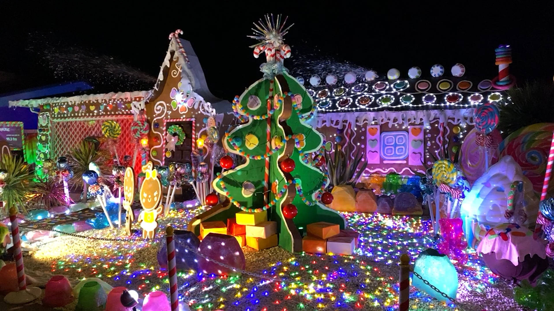 life size gingerbread house decoration, nighttime display, candy-themed structures, Full HD Desktop Wallpaper