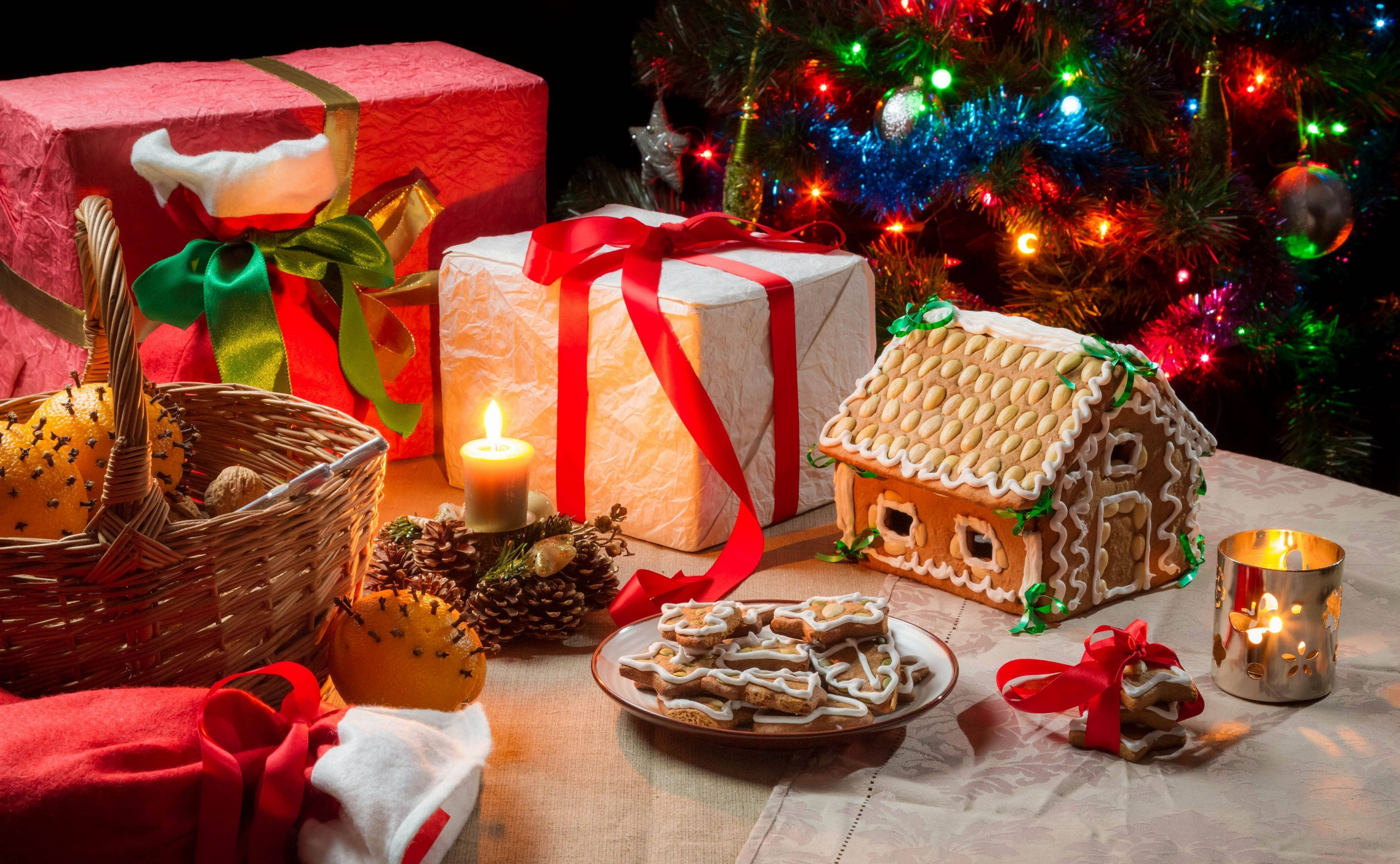 Gingerbread house, Christmas tabletop scene, lit candles, 4K Desktop Wallpaper