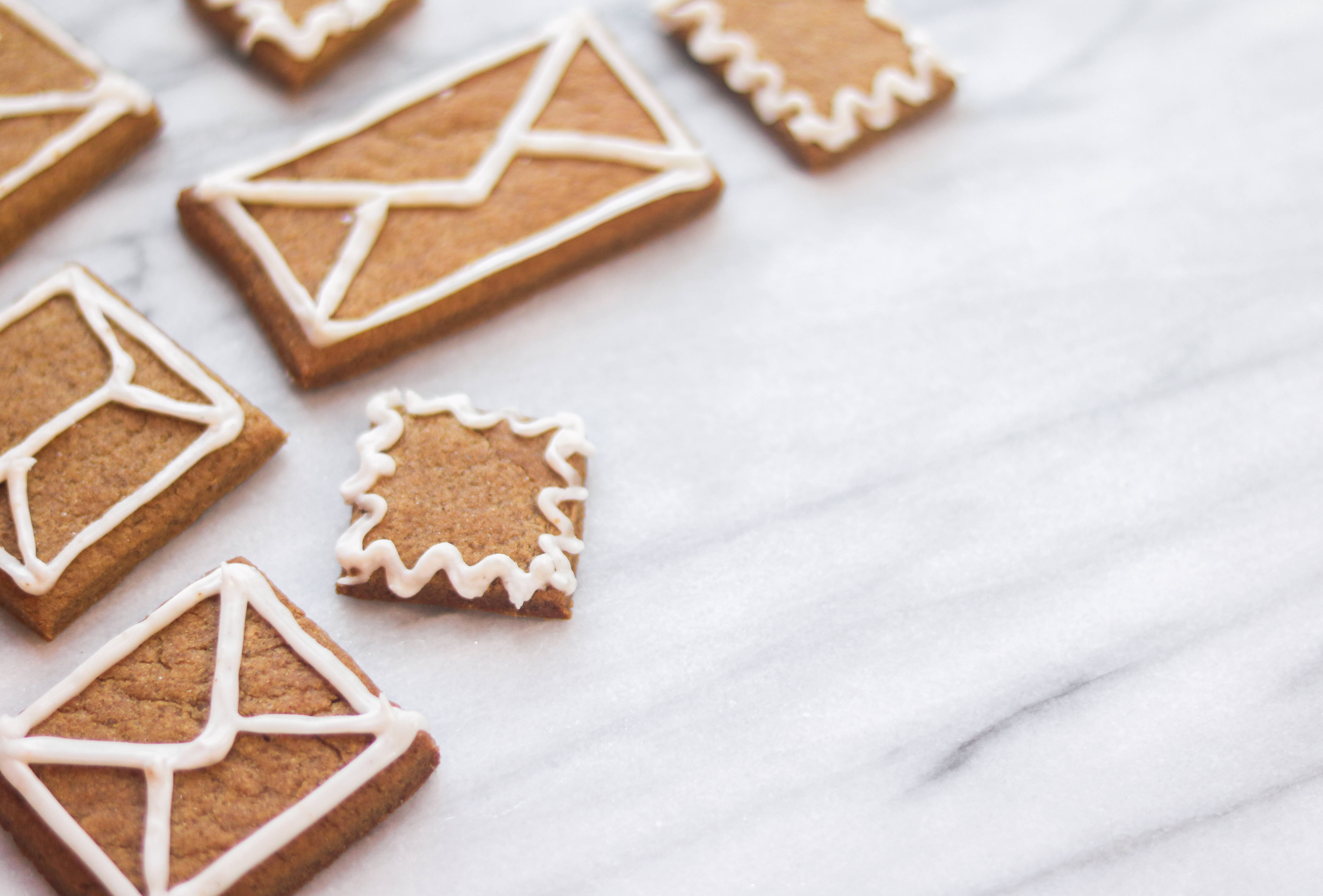 envelope gingerbread cookies, postage stamps, white marble surface, 5K Desktop Wallpaper