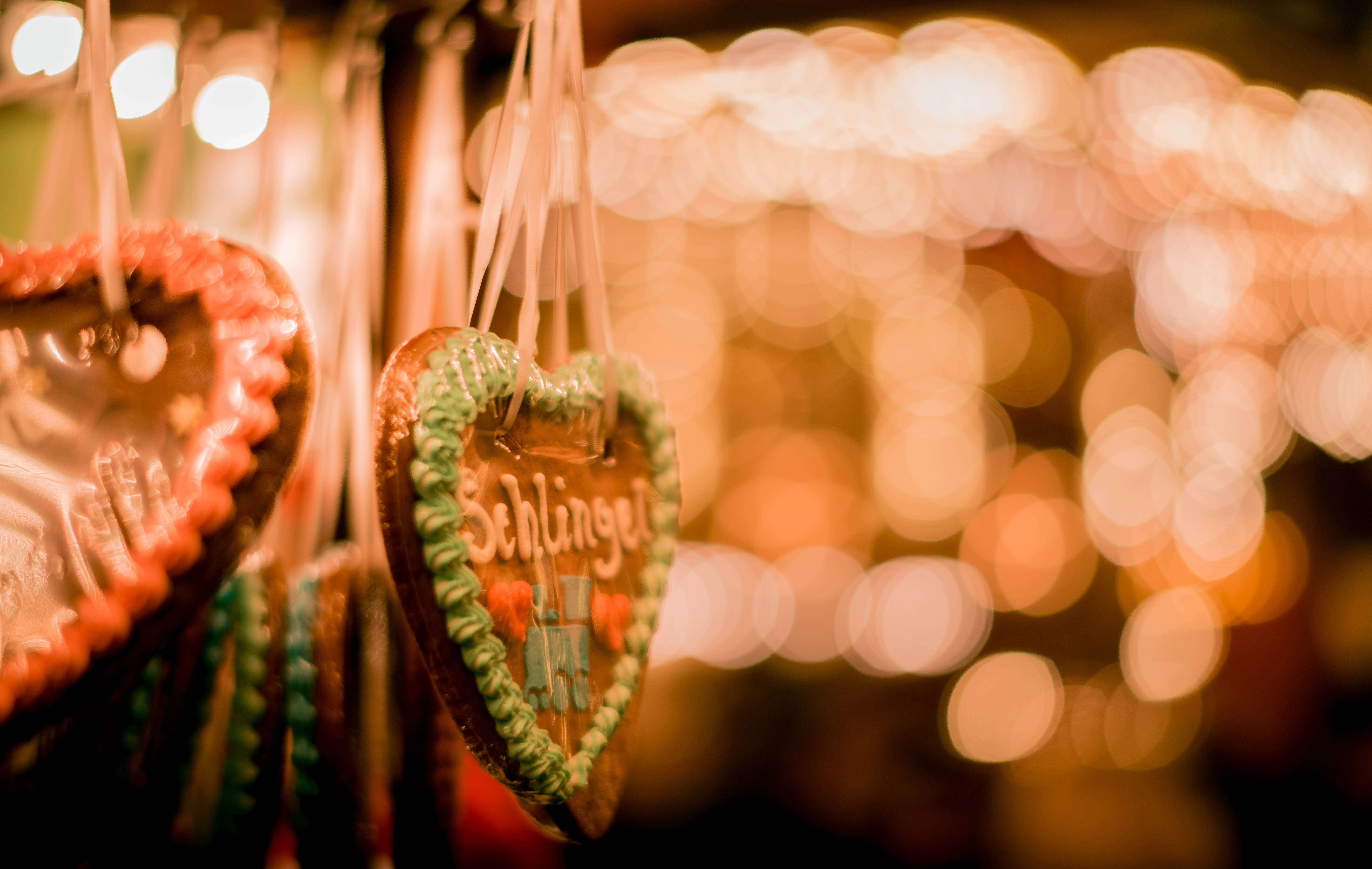Heart-shaped gingerbread cookies, colorful icing, warm bokeh, 8K Desktop Wallpaper