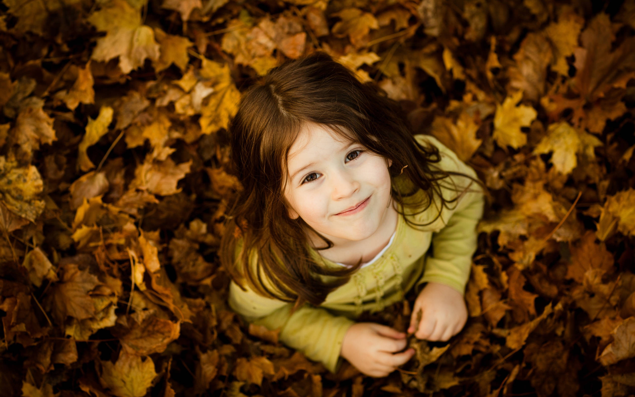 Radiant Young Girl, golden autumn leaves, smiling child, 2K Desktop Wallpaper