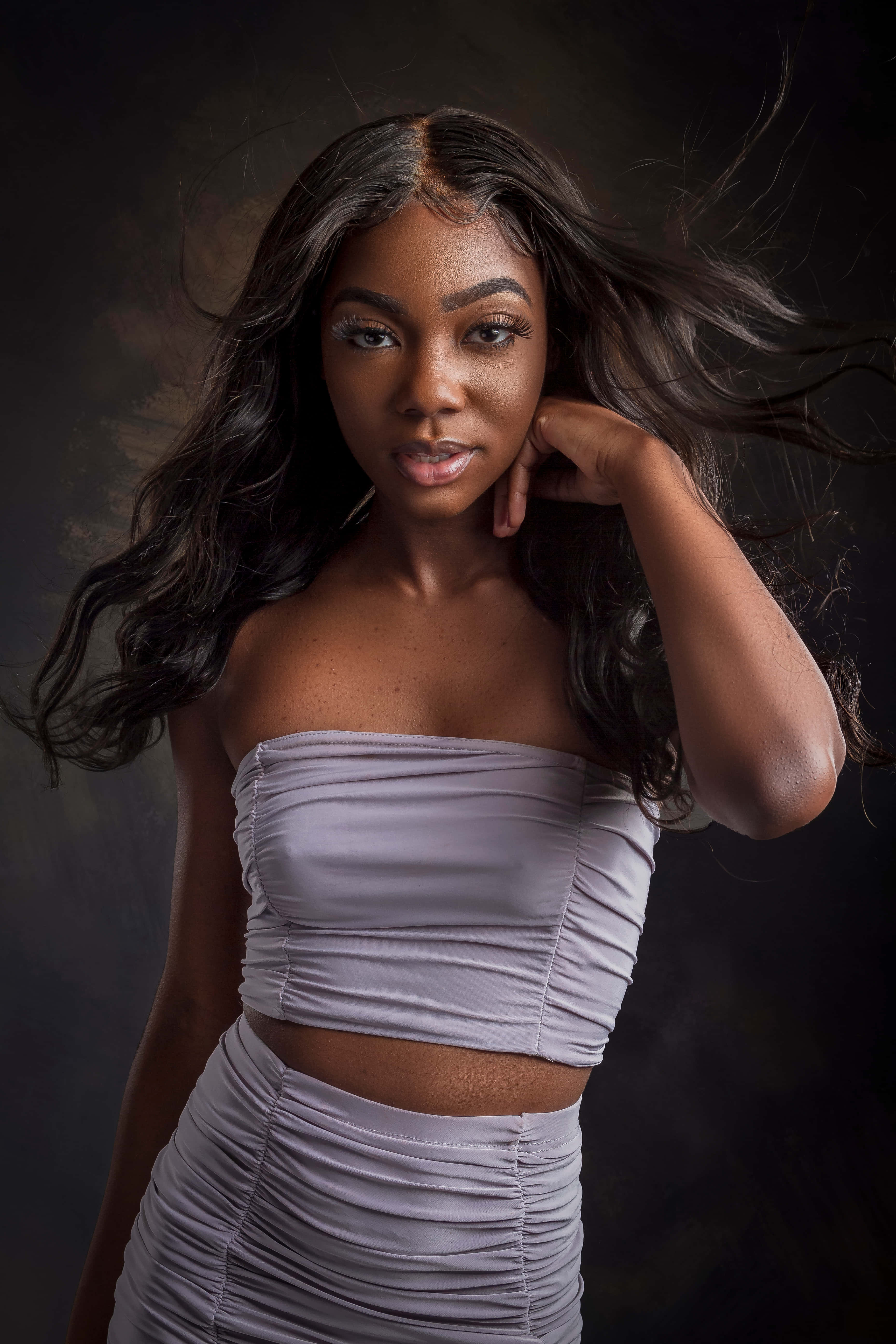ruched lavender two-piece outfit, flowing dark hair, moody dark backdrop, 5K Phone Wallpaper