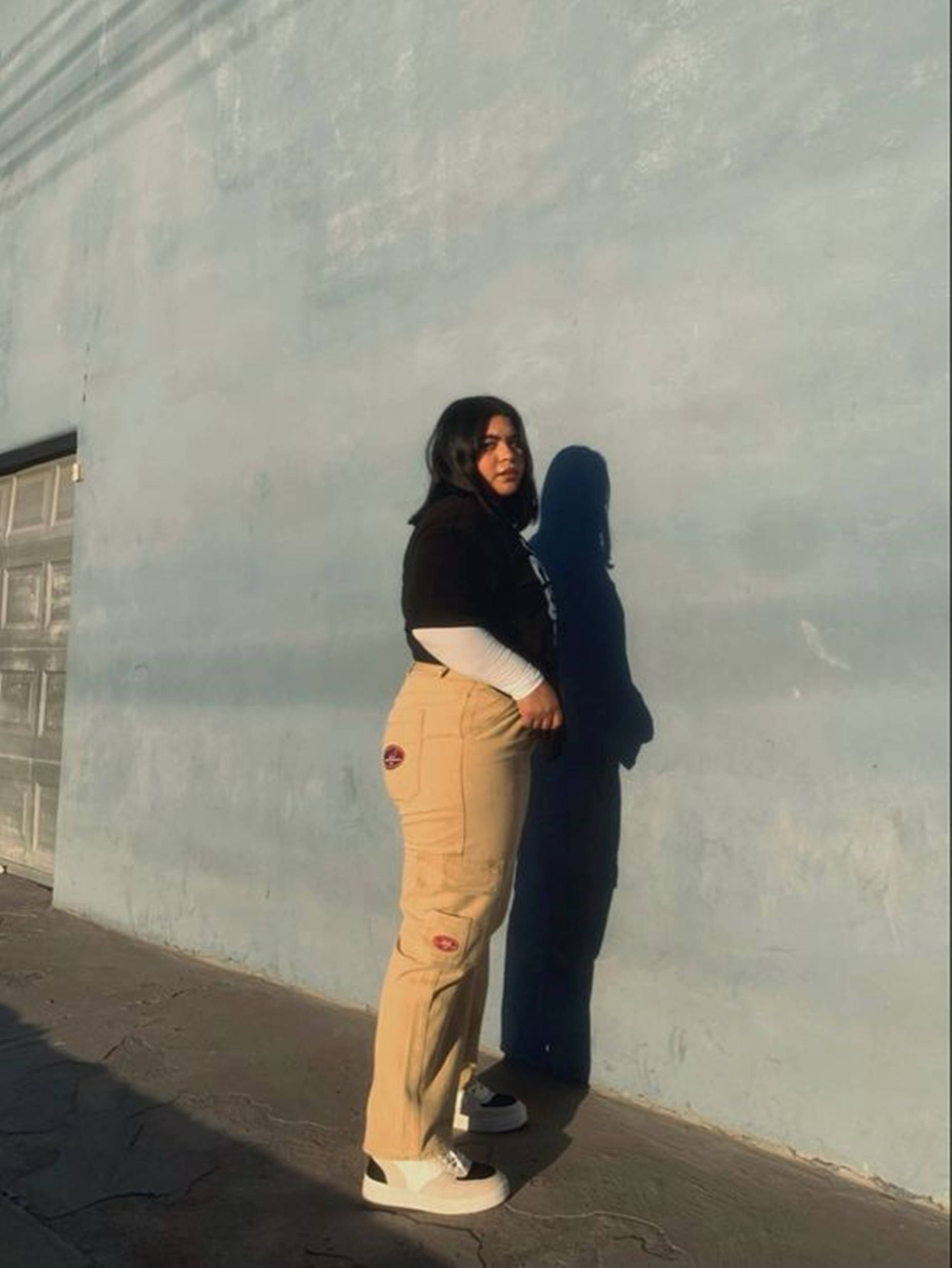 chubby teen shadow, pale blue wall, golden hour light, Full HD Phone Wallpaper