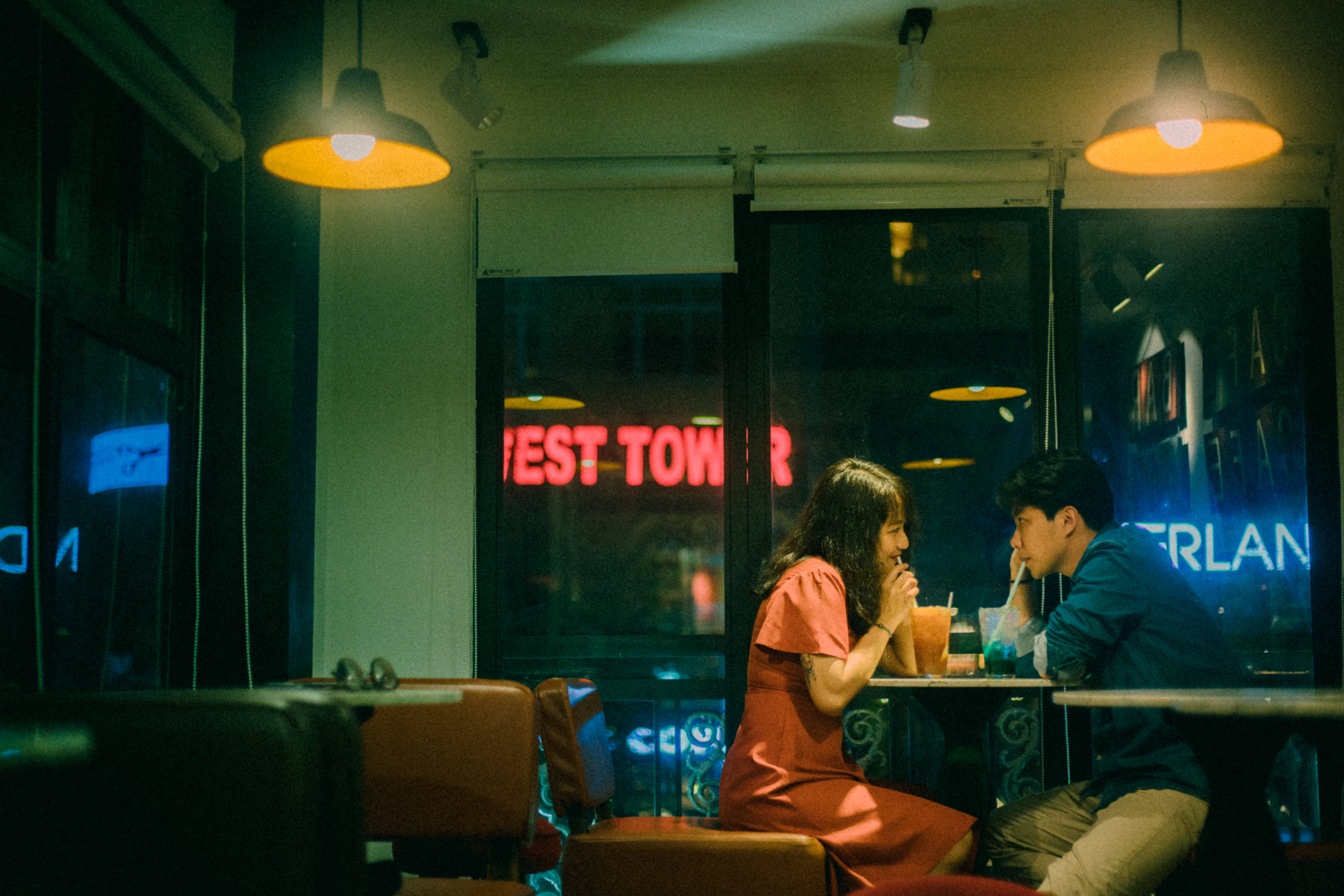 boyfriend and girlfriend, warm pendant lights, dimly lit cafe, 8K Desktop Wallpaper