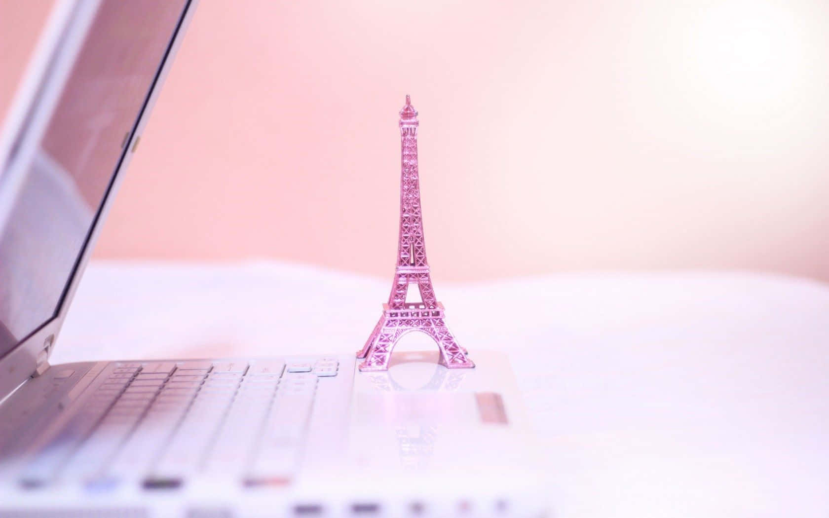 pink Eiffel Tower figurine, open laptop, soft white surface, HD Desktop Wallpaper