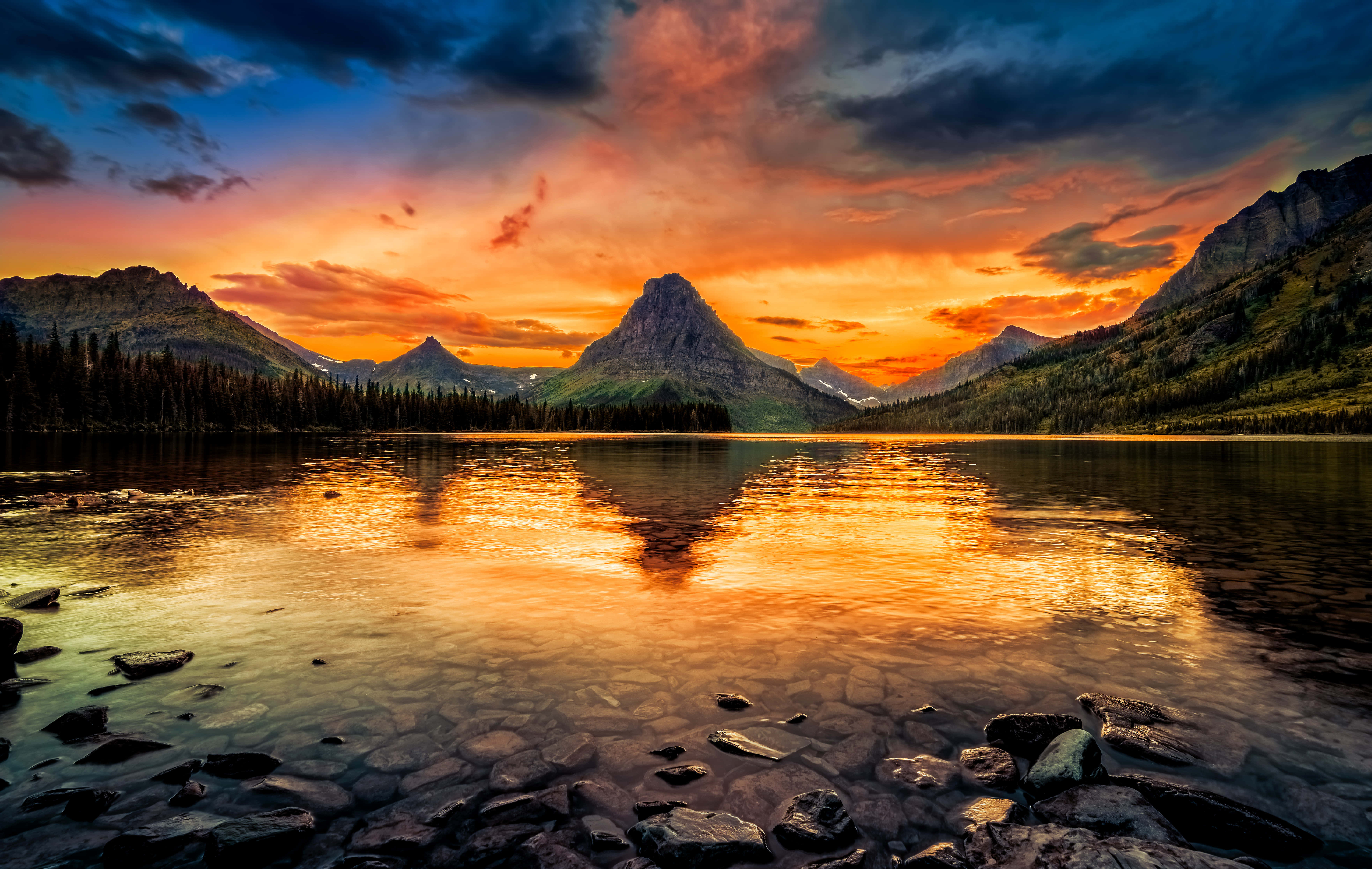 Glacier National Park, fiery orange and pink sunset, rugged peaks, 5K Desktop Wallpaper