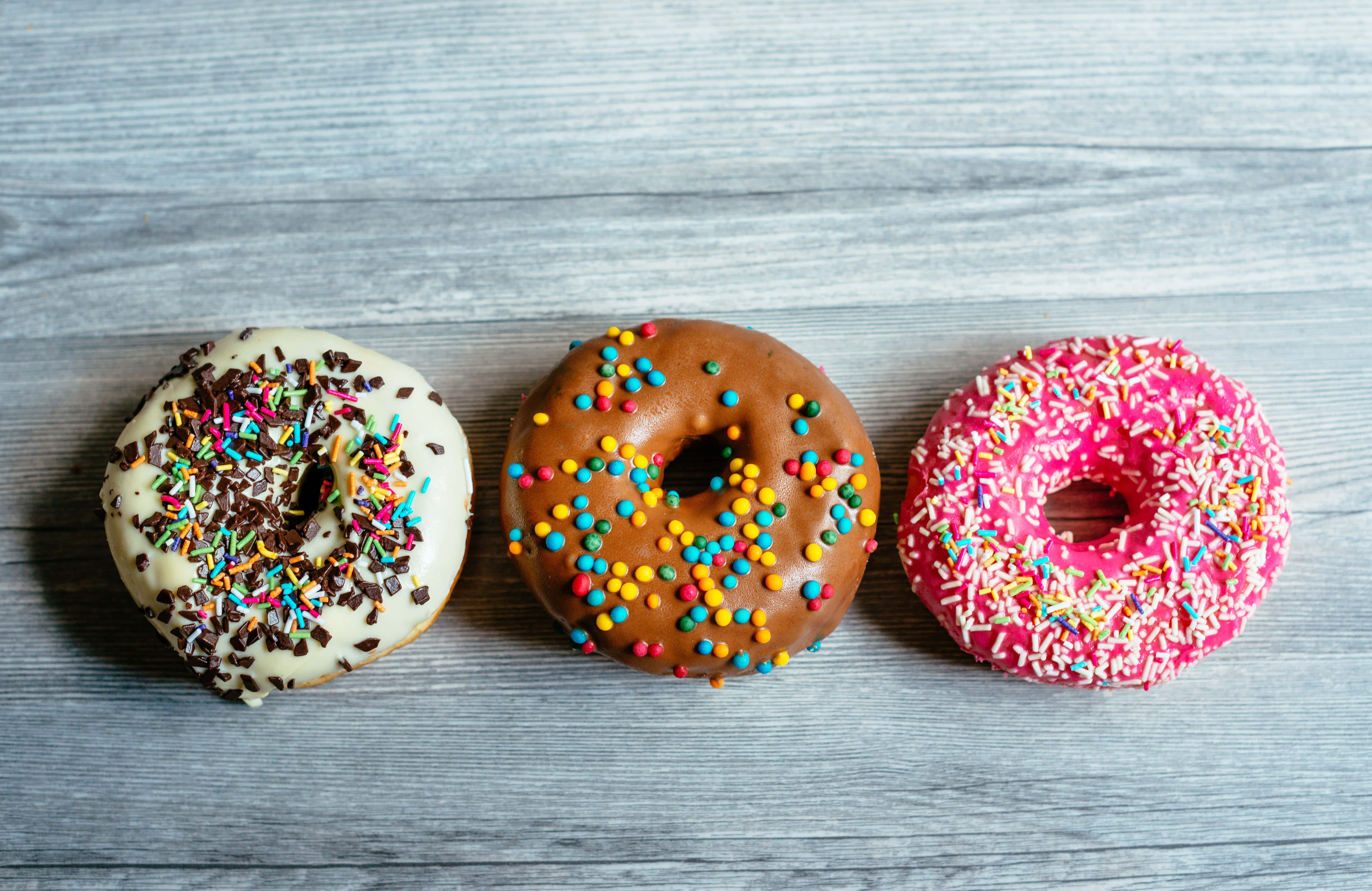 glazed donut 5000 x 3247, rainbow sprinkles, gray wooden surface, 4K Desktop Wallpaper