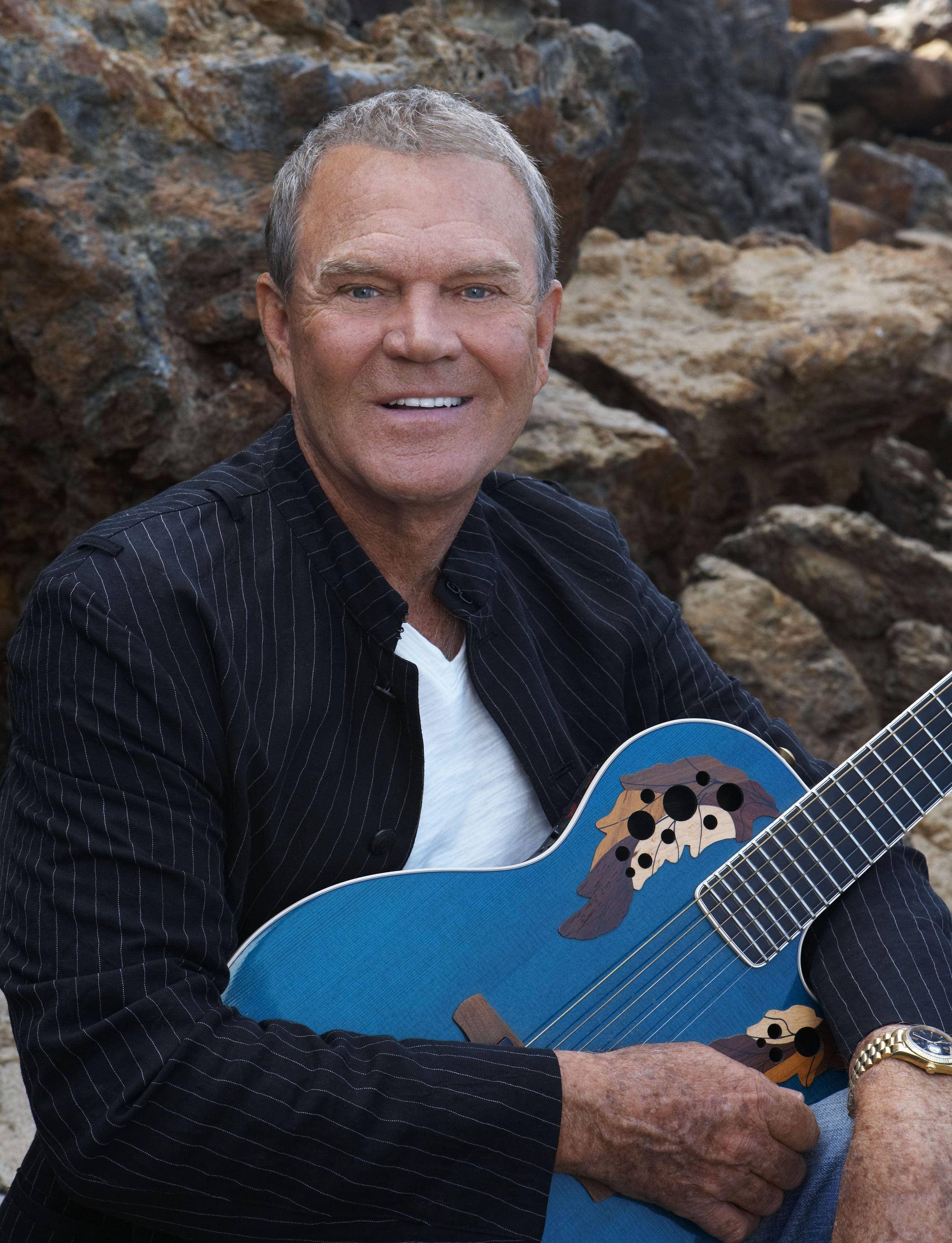 Glen Campbell, blue acoustic guitar, rugged rocks, 2K Phone Wallpaper
