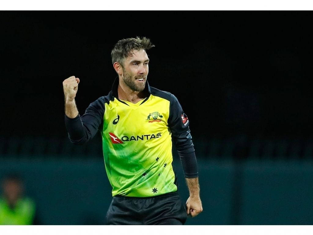 Glenn Maxwell, vibrant yellow and green jersey, stadium lights, SD Desktop Wallpaper