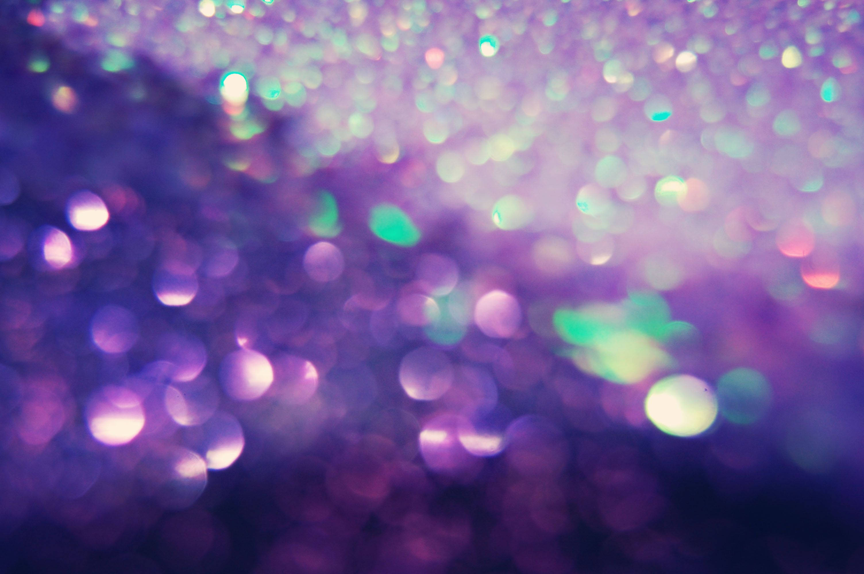 sparkly, shimmering purple and teal glitter particles, dark background, 2K Desktop Wallpaper