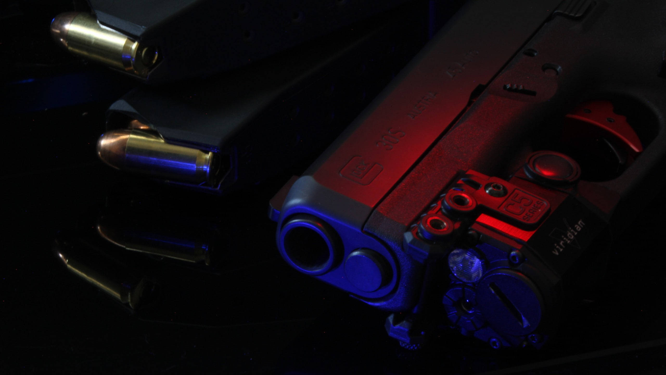 Glock, red and blue lighting, black reflective surface, 2K Desktop Wallpaper
