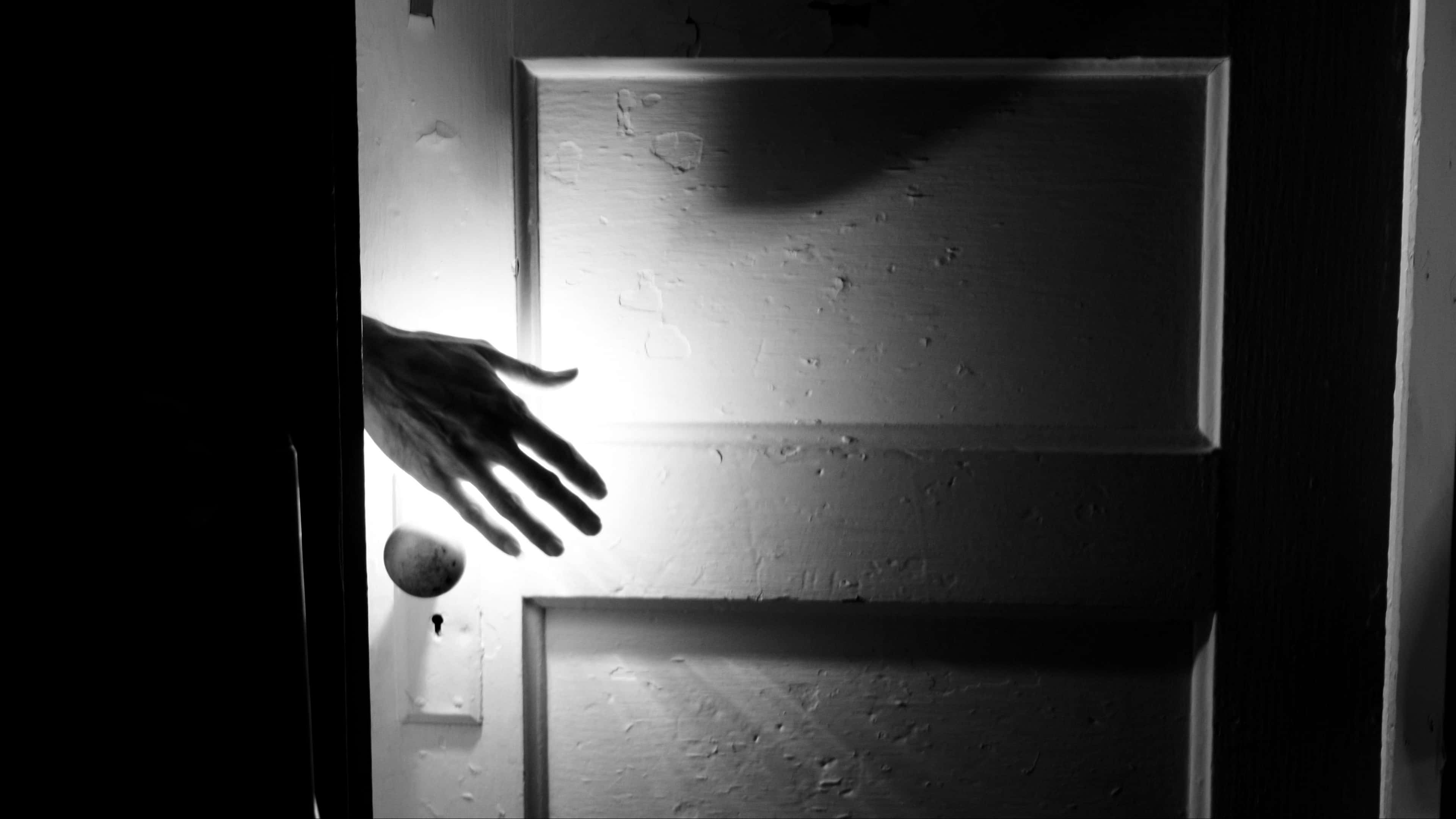 gloomy, shadowed hand, brightly lit door, 4K Desktop Wallpaper