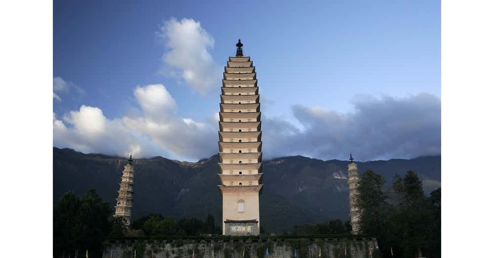 three pagodas, ancient stone pagodas, dramatic mountain backdrop, SD Desktop Wallpaper