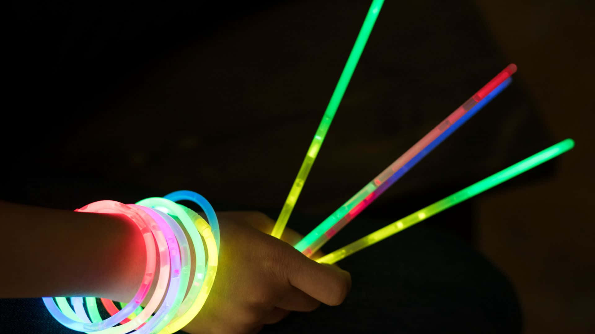glowing neon bracelets, vibrant colors, dark background, Full HD Desktop Wallpaper