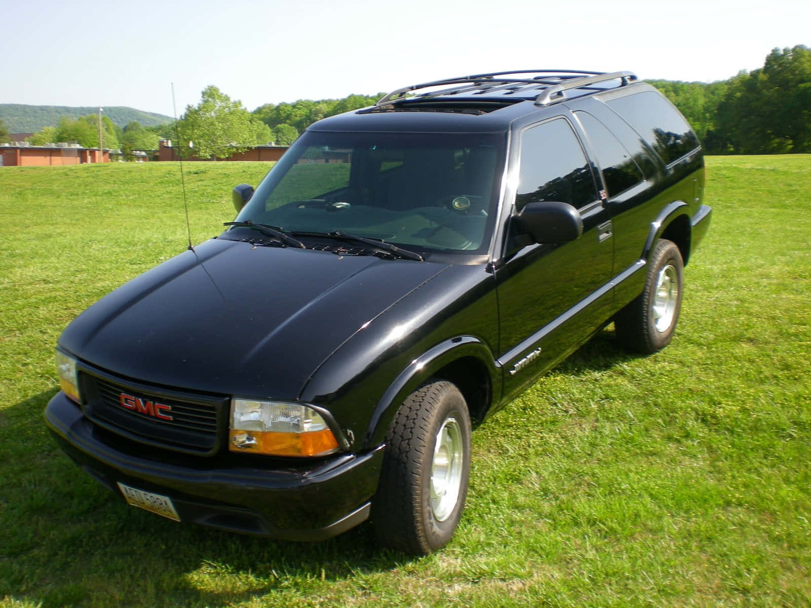 GMC Jimmy, sleek black, vibrant green lawn, HD Desktop Wallpaper